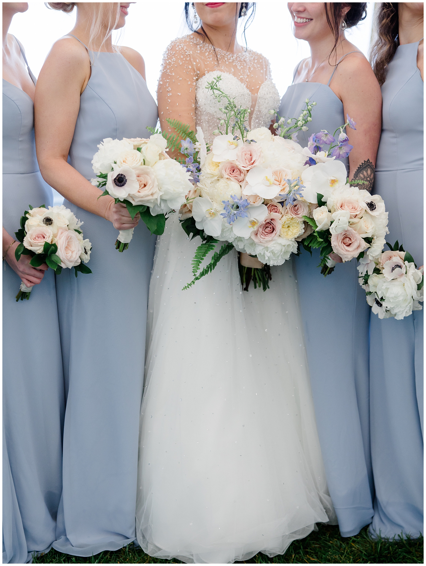 bride and bridesmaids in dusty blue dresses and light and airy bouquets