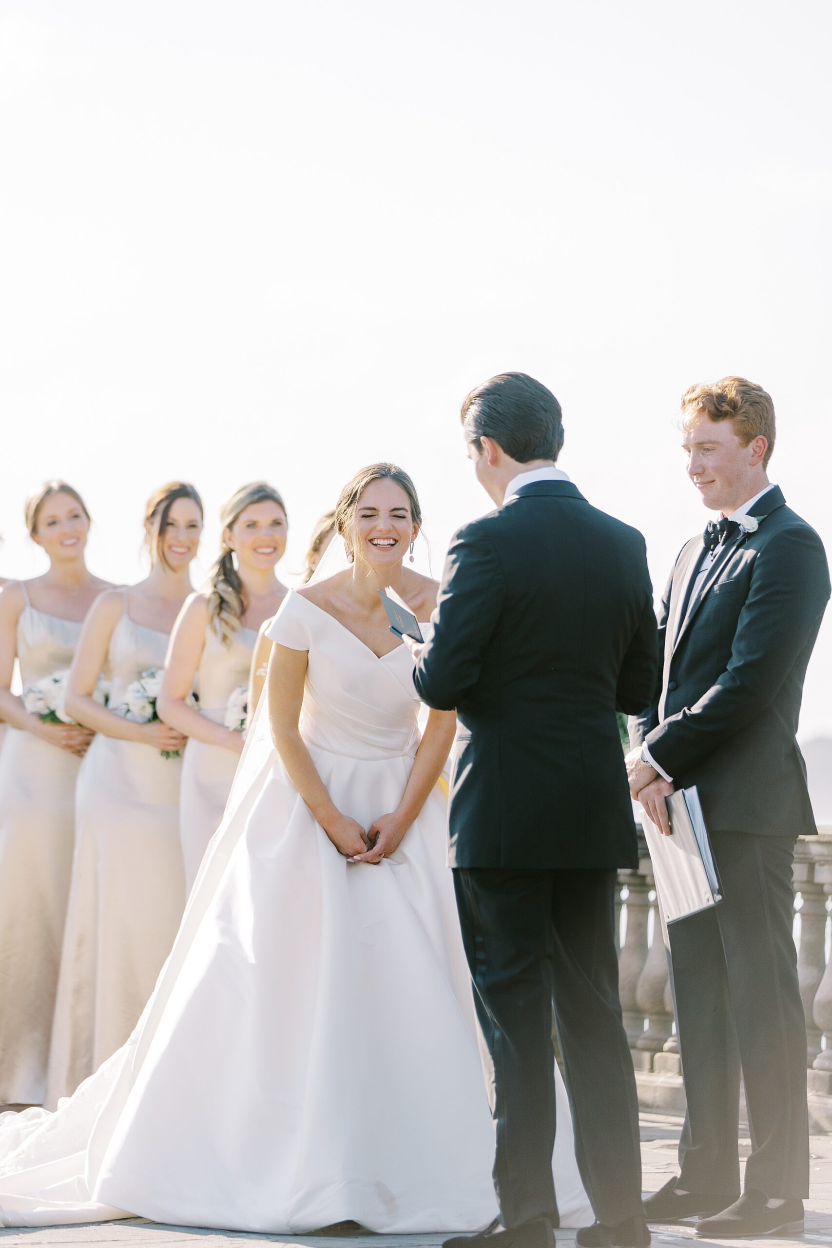 bride laughs during vow exchange at Castle Hill Inn Coastal Wedding