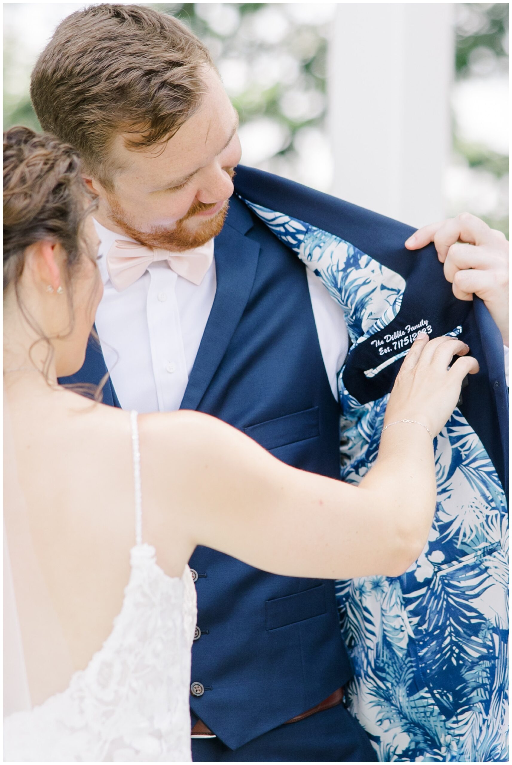 groom showing bride personalized suite jacket