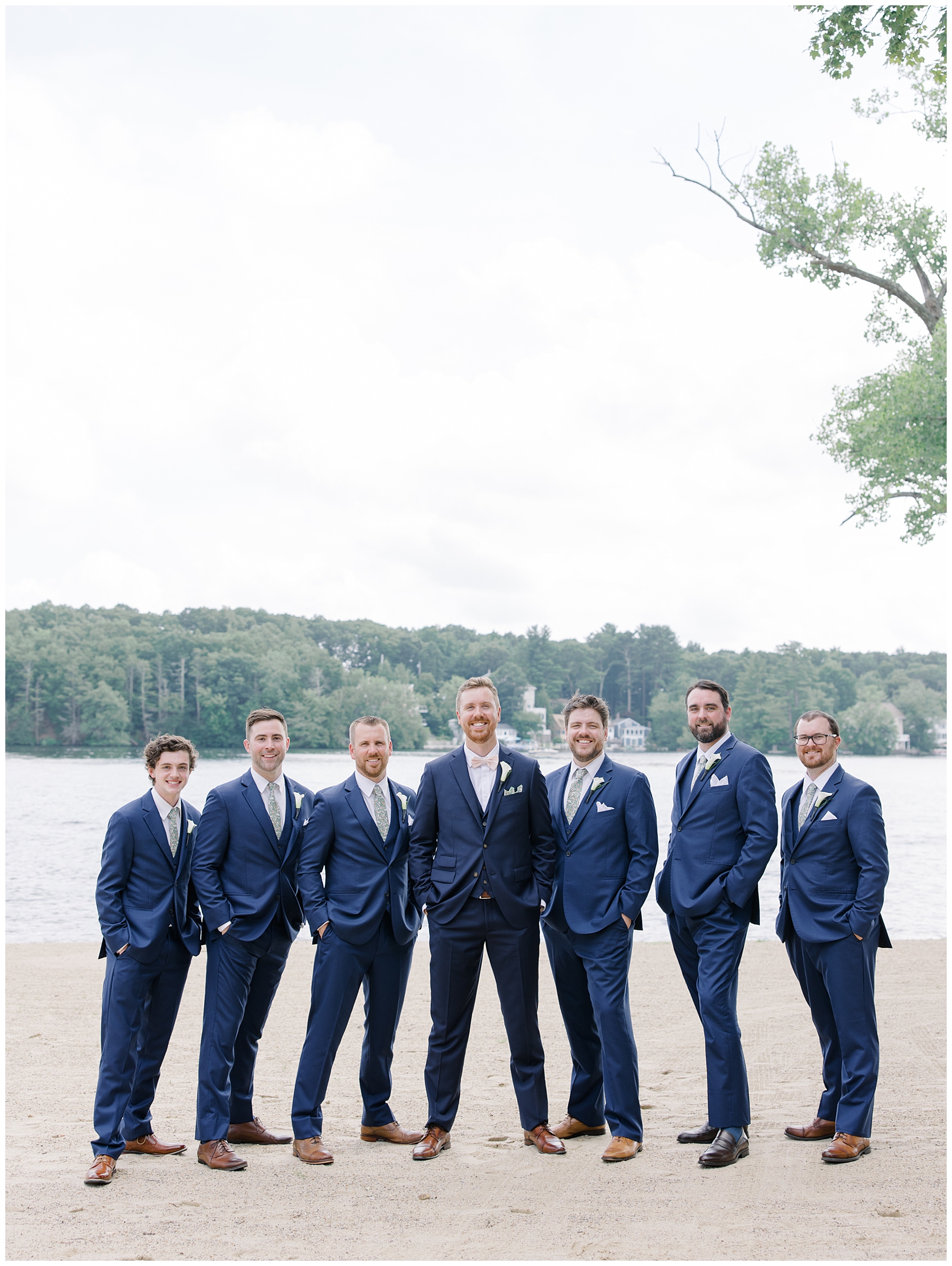 groom with groomsmen by the lake