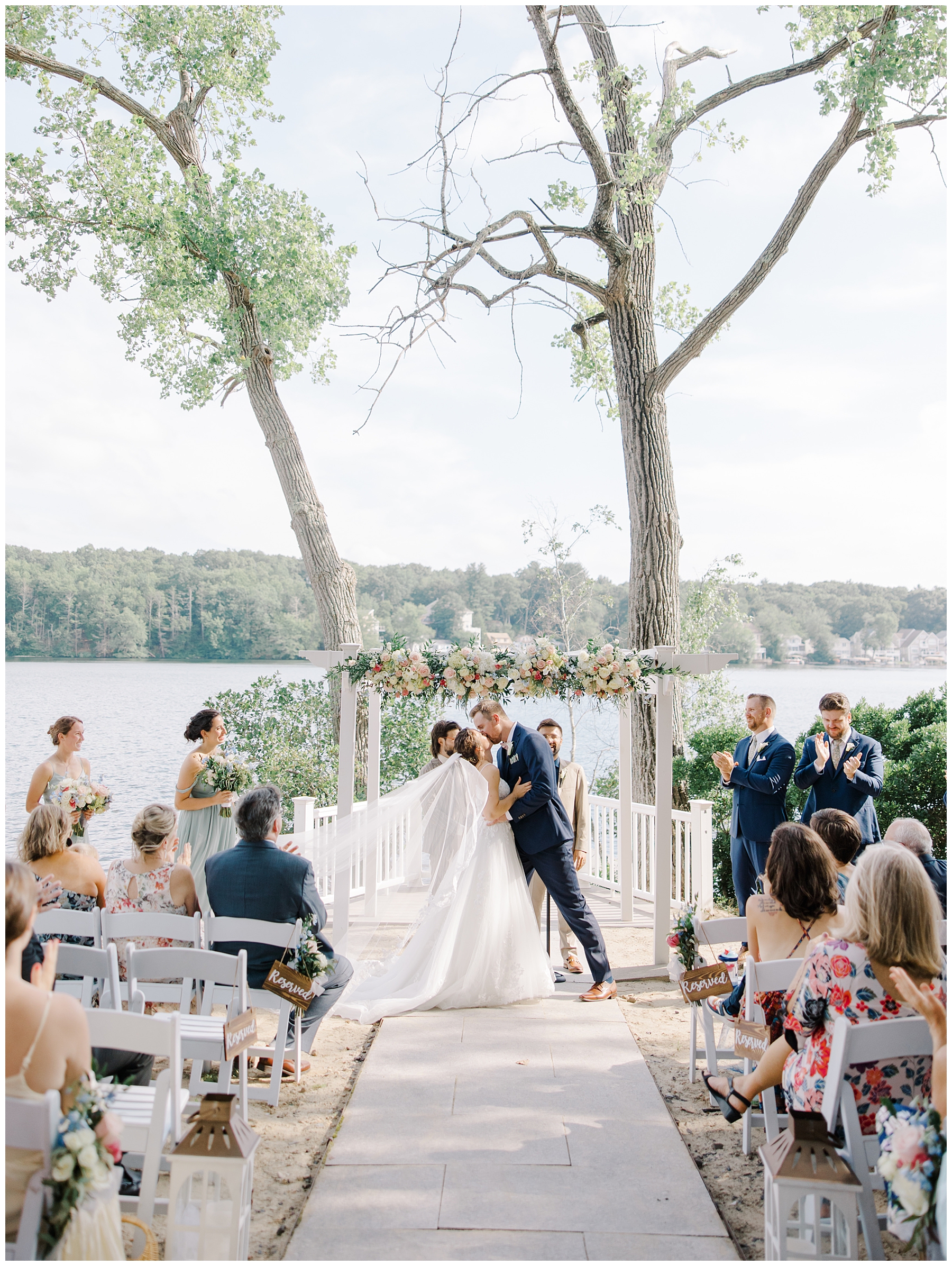 couple tie the knot at waterfront wedding ceremony at Lake Pearl