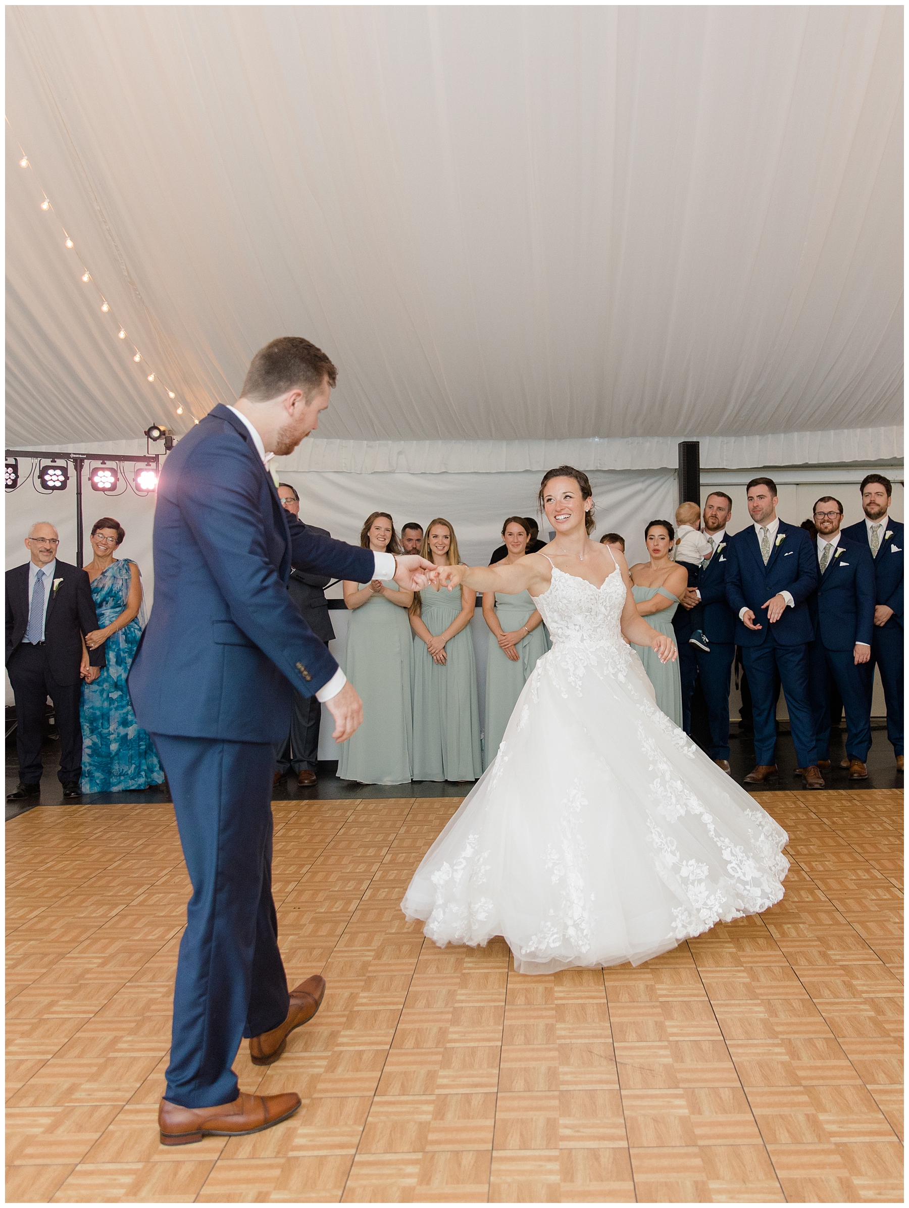 groom spins bride out on the dance floor