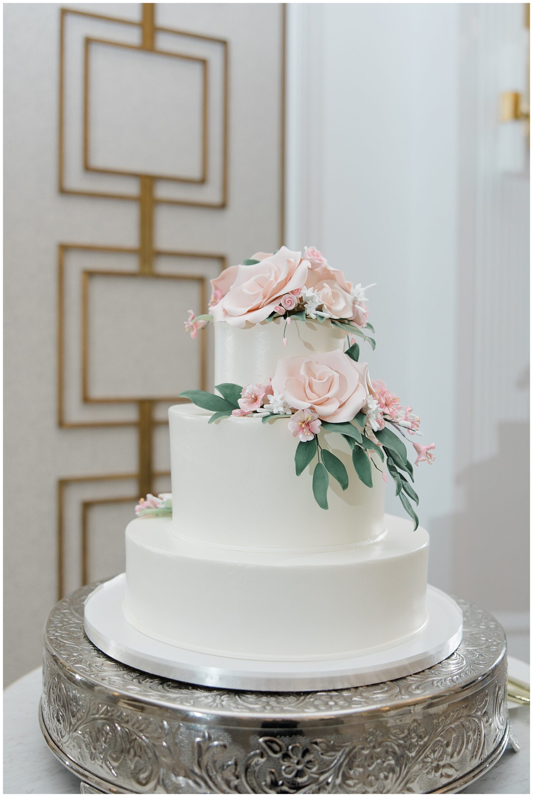 classic wedding cake with pink flower details 