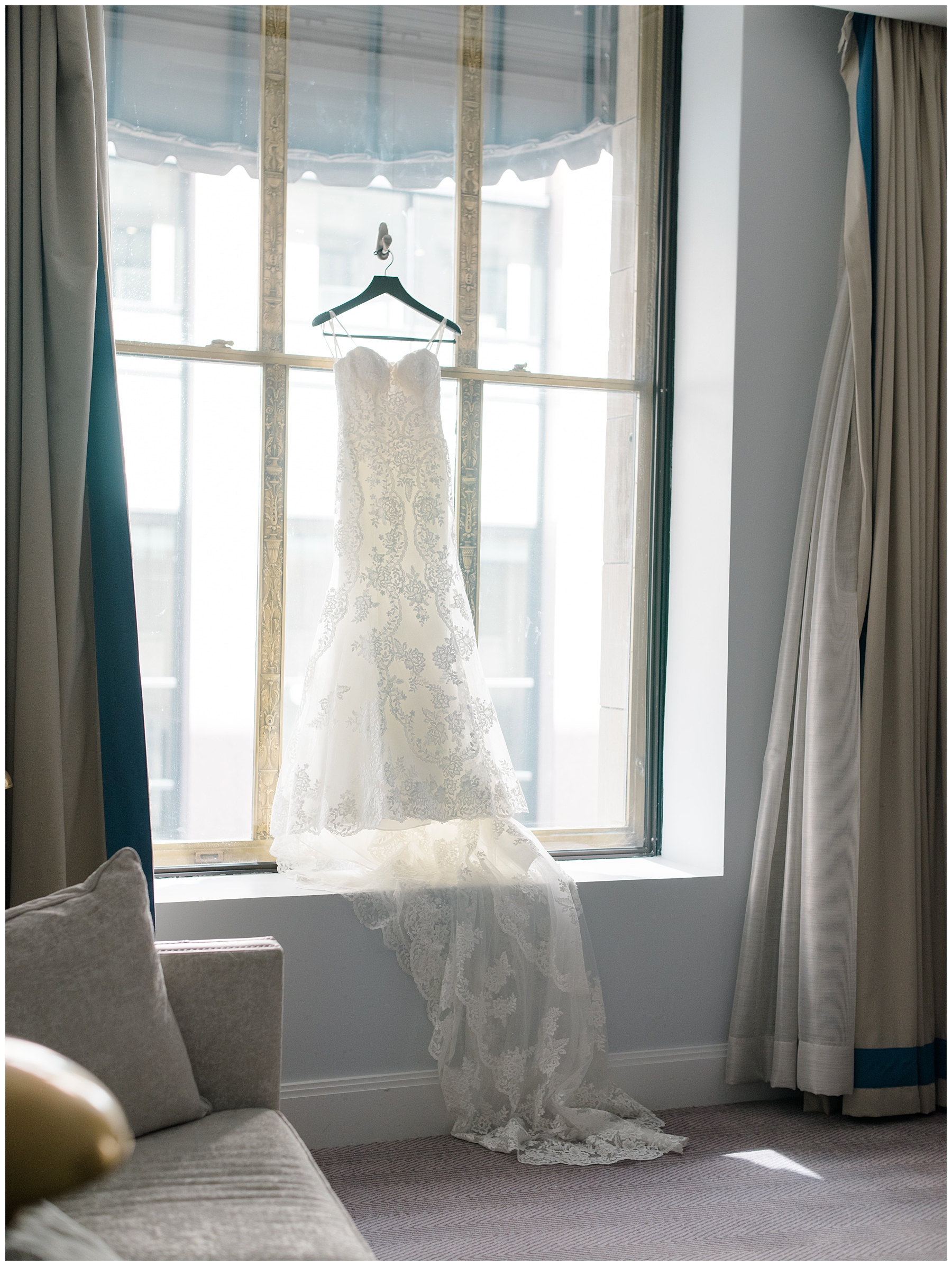 wedding dress hanging from window