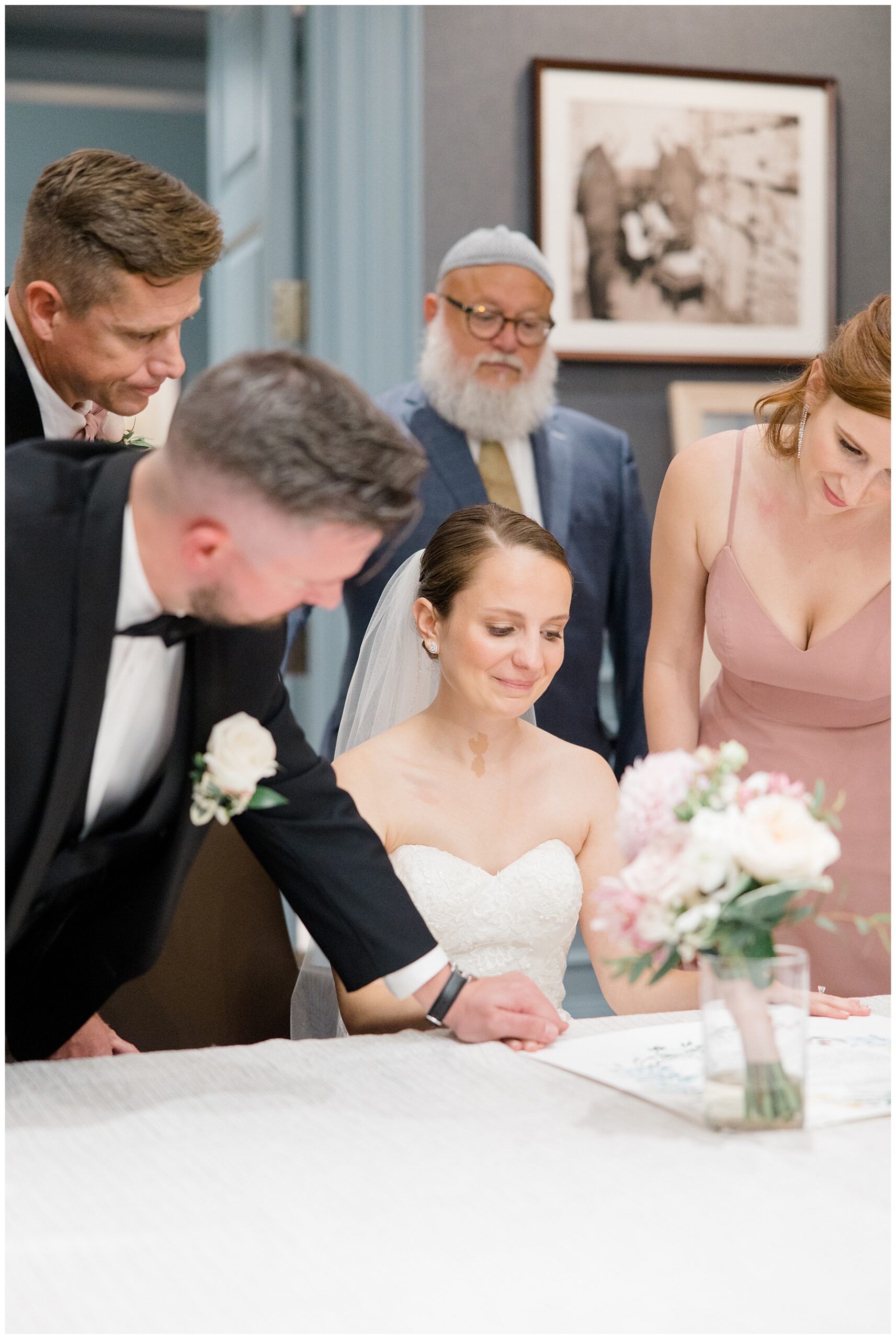 bride and groom sign their marriage certificate