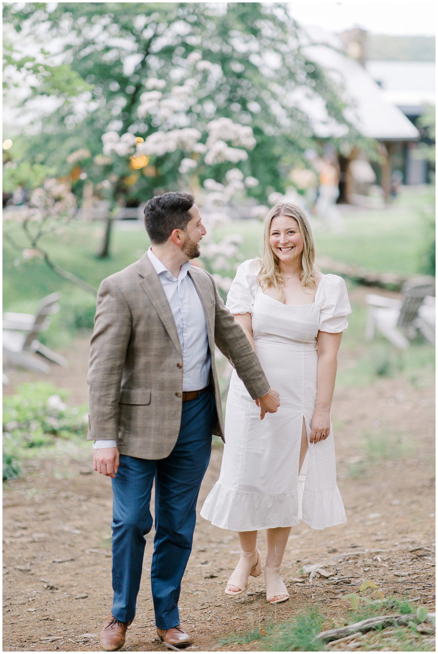 couple walk the grounds of brewery during engagement session