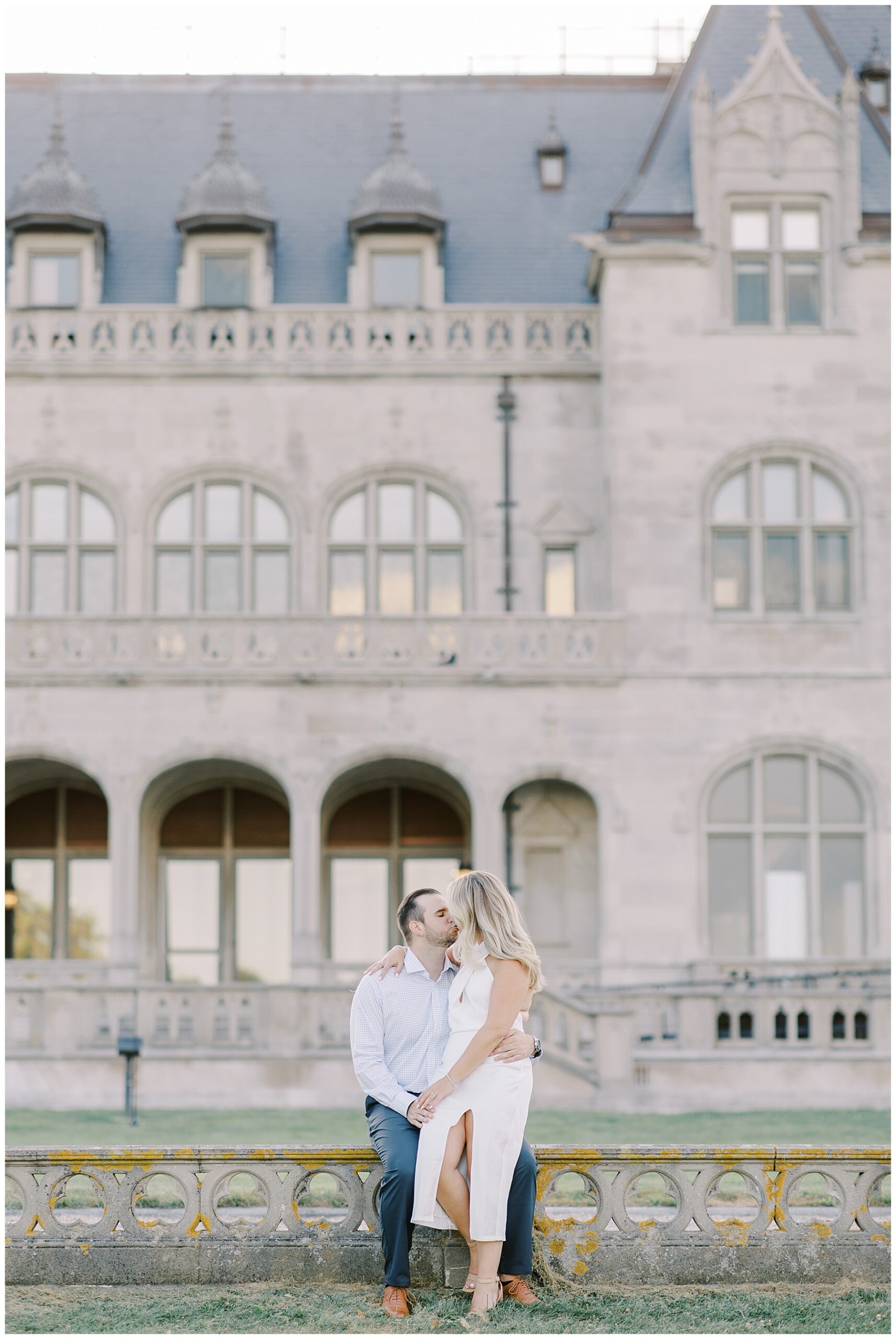 couple kiss in front of historic building