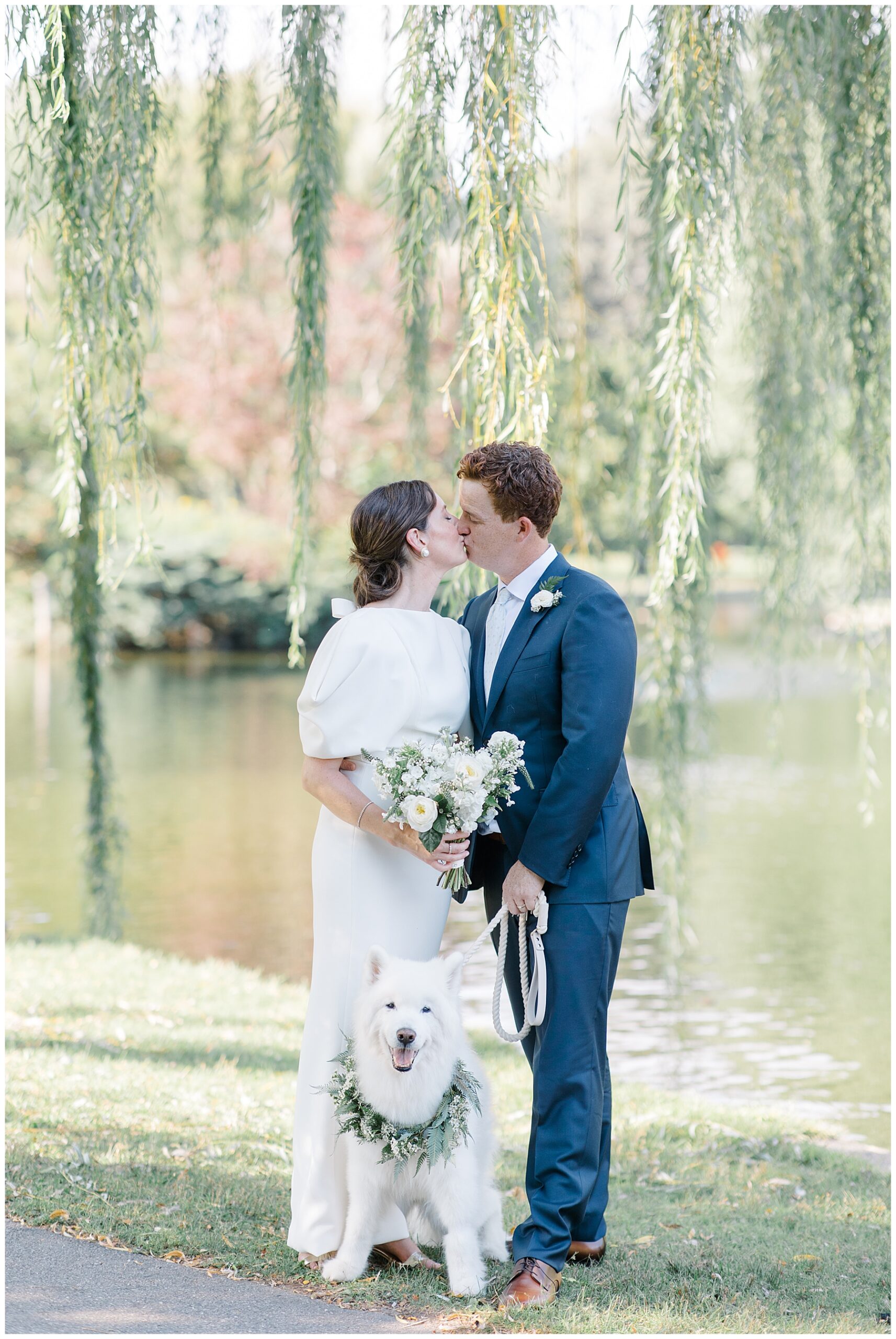 newlyweds kiss under weeping willow tree
