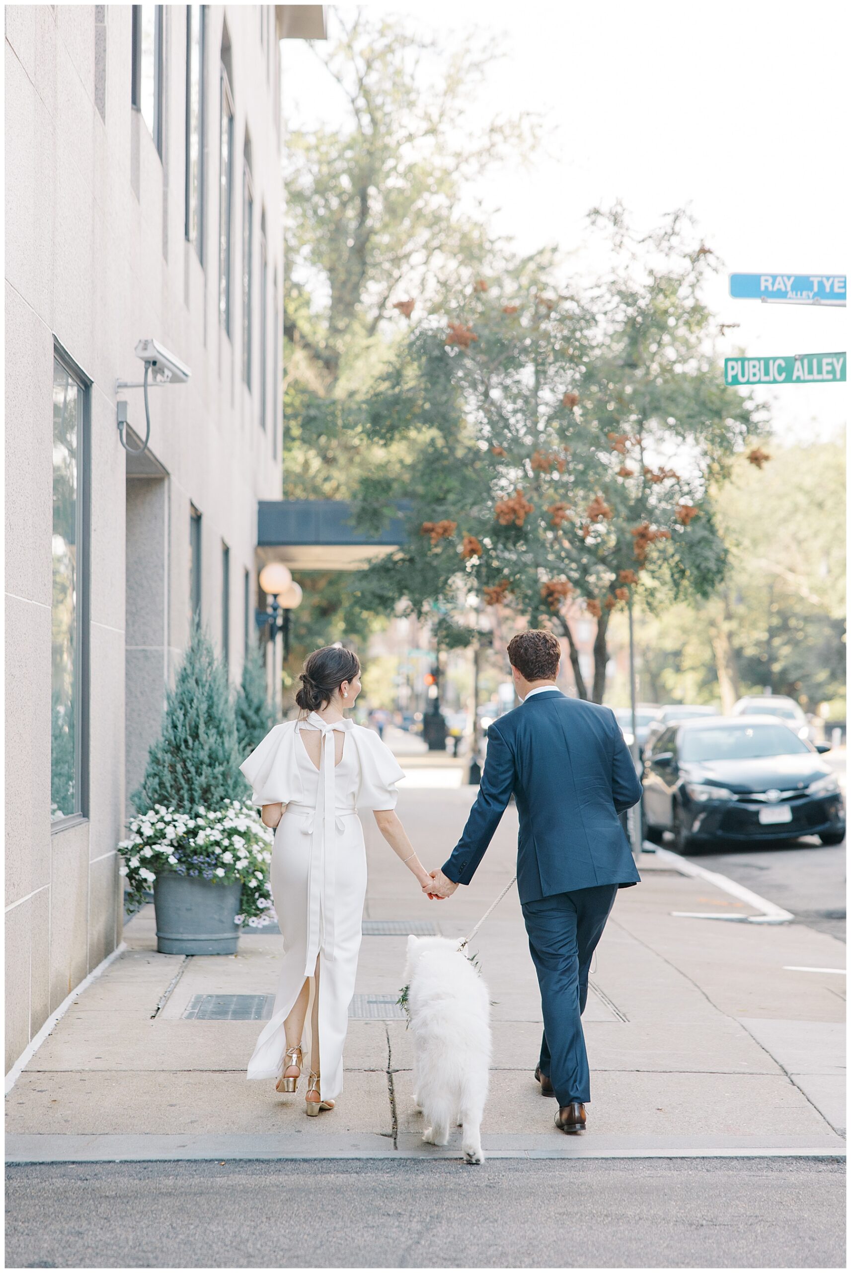 newlyweds walk down Boston street with dog