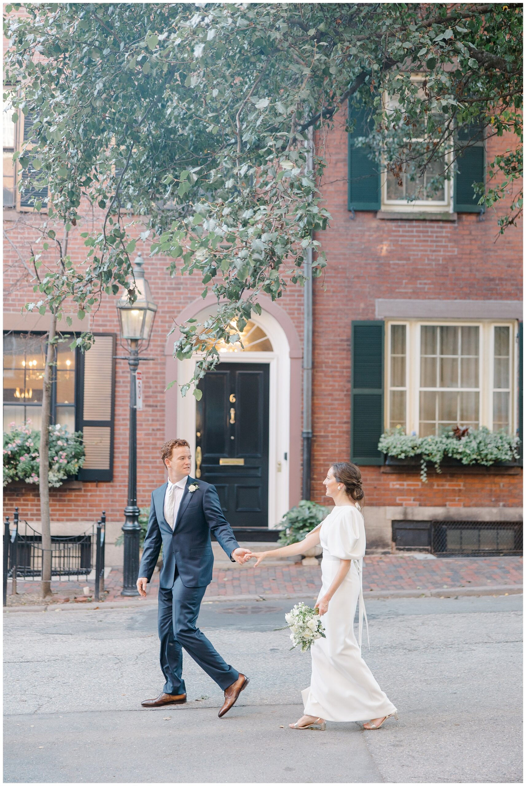 newlyweds walk down Boston street 
