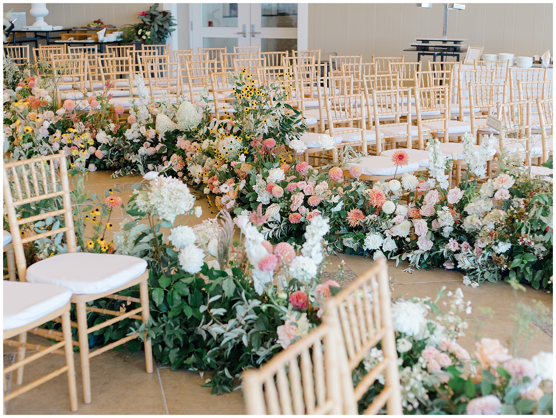 elegant garden flowers line the aisle at wedding ceremony 