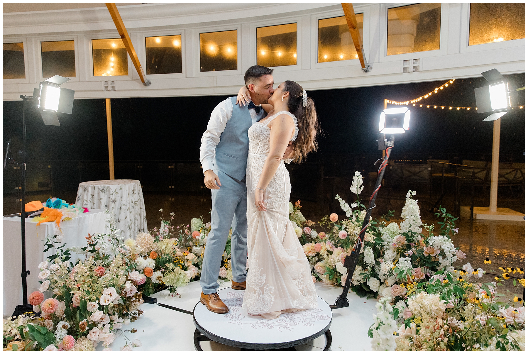 bride and groom kiss on dance platform