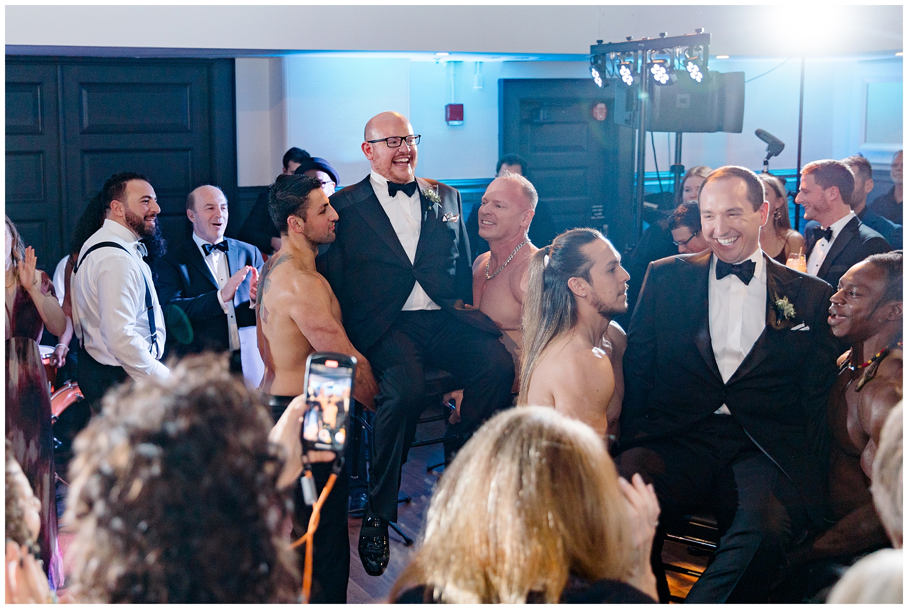 grooms lifted up in chairs 
