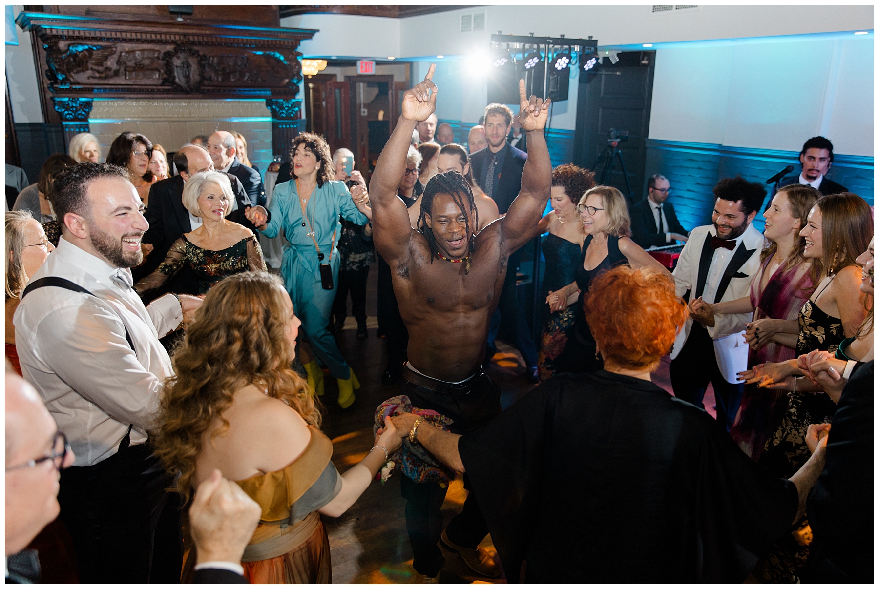 dancers lift up grooms at wedding 