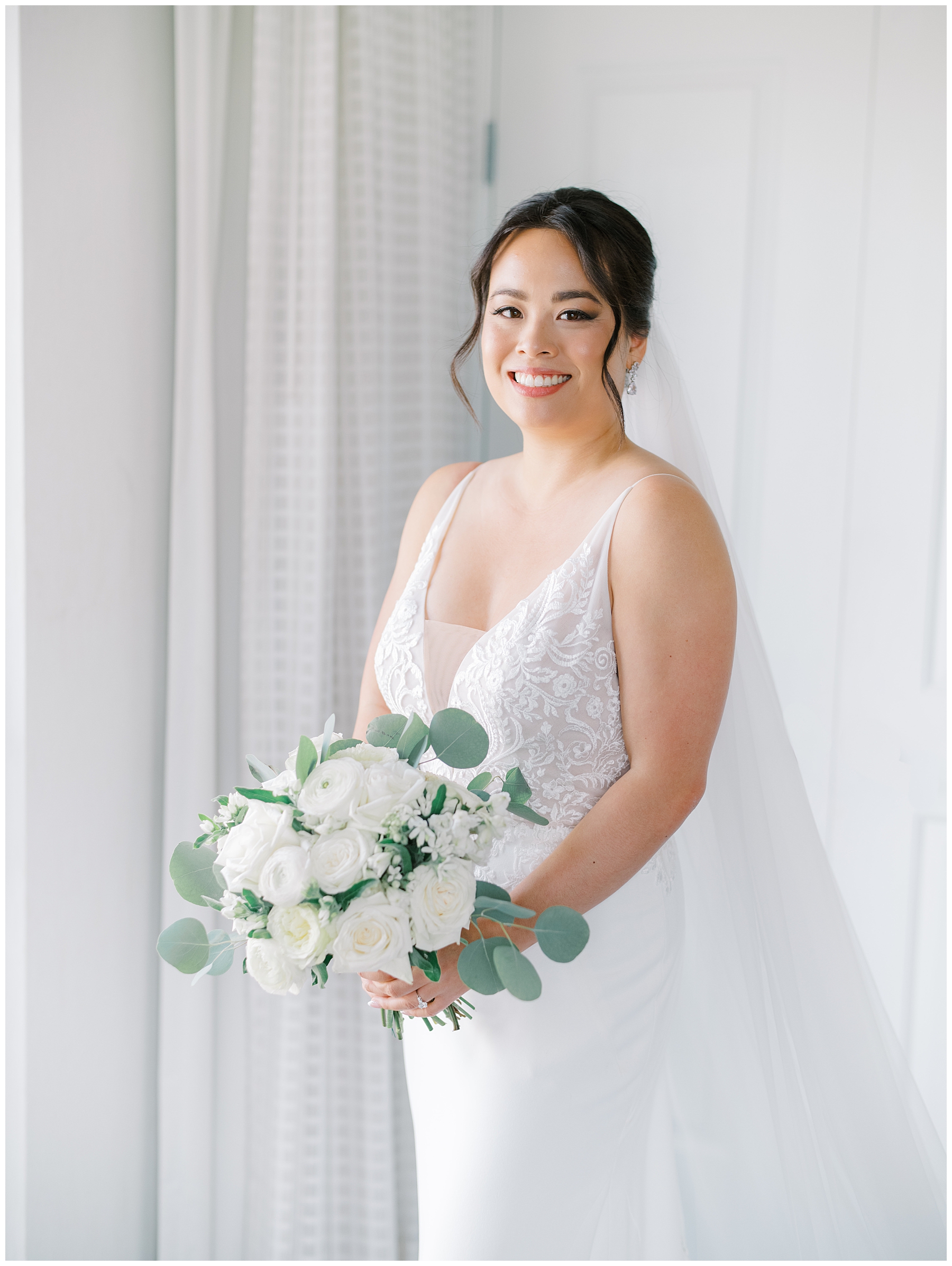 bridal portraits holding white rose bouquets with eucalyptus leaves