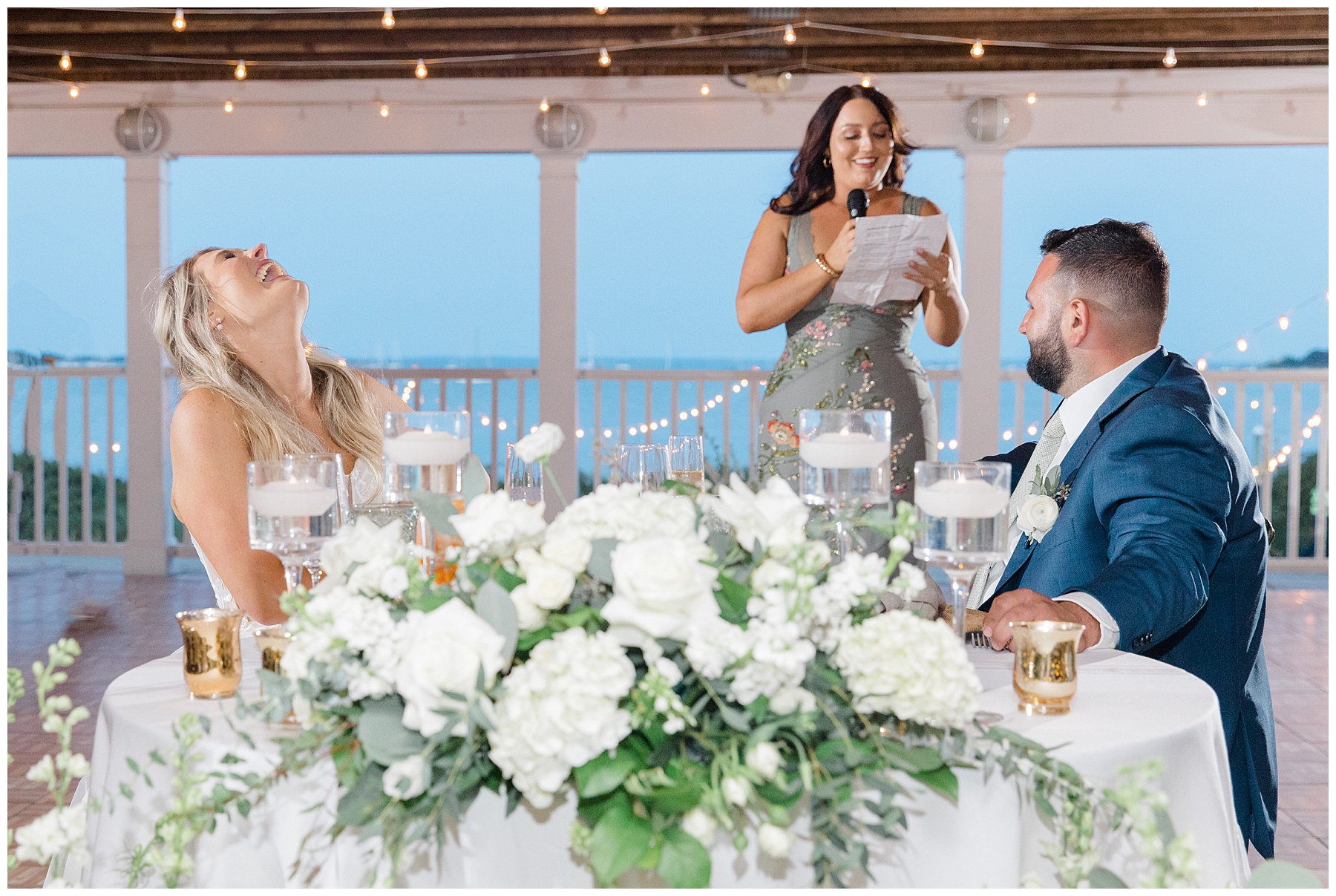 newlyweds laugh during wedding toast 