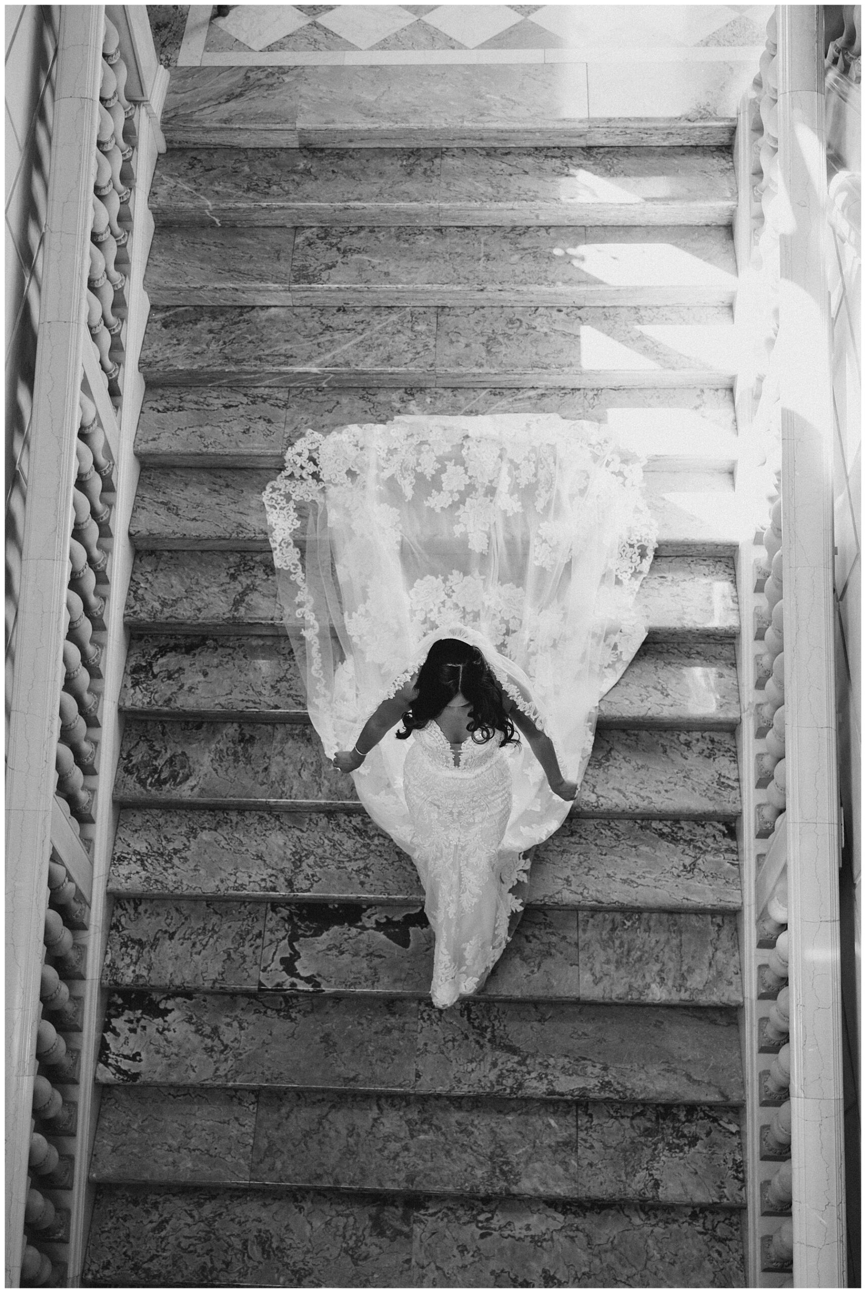 bride walks down grand staircase 
