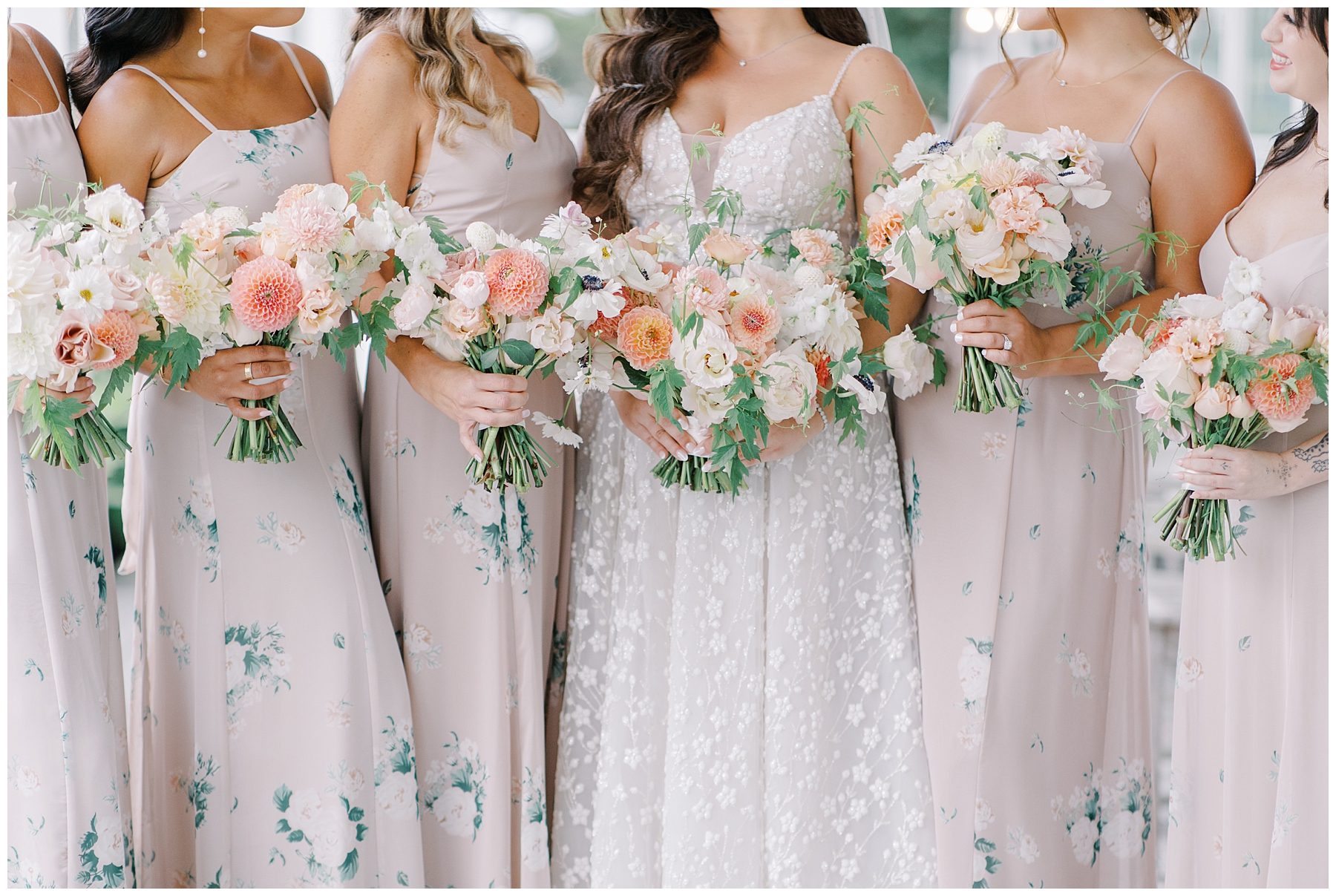 bridesmaids and bride holding beautiful wedding bouquets