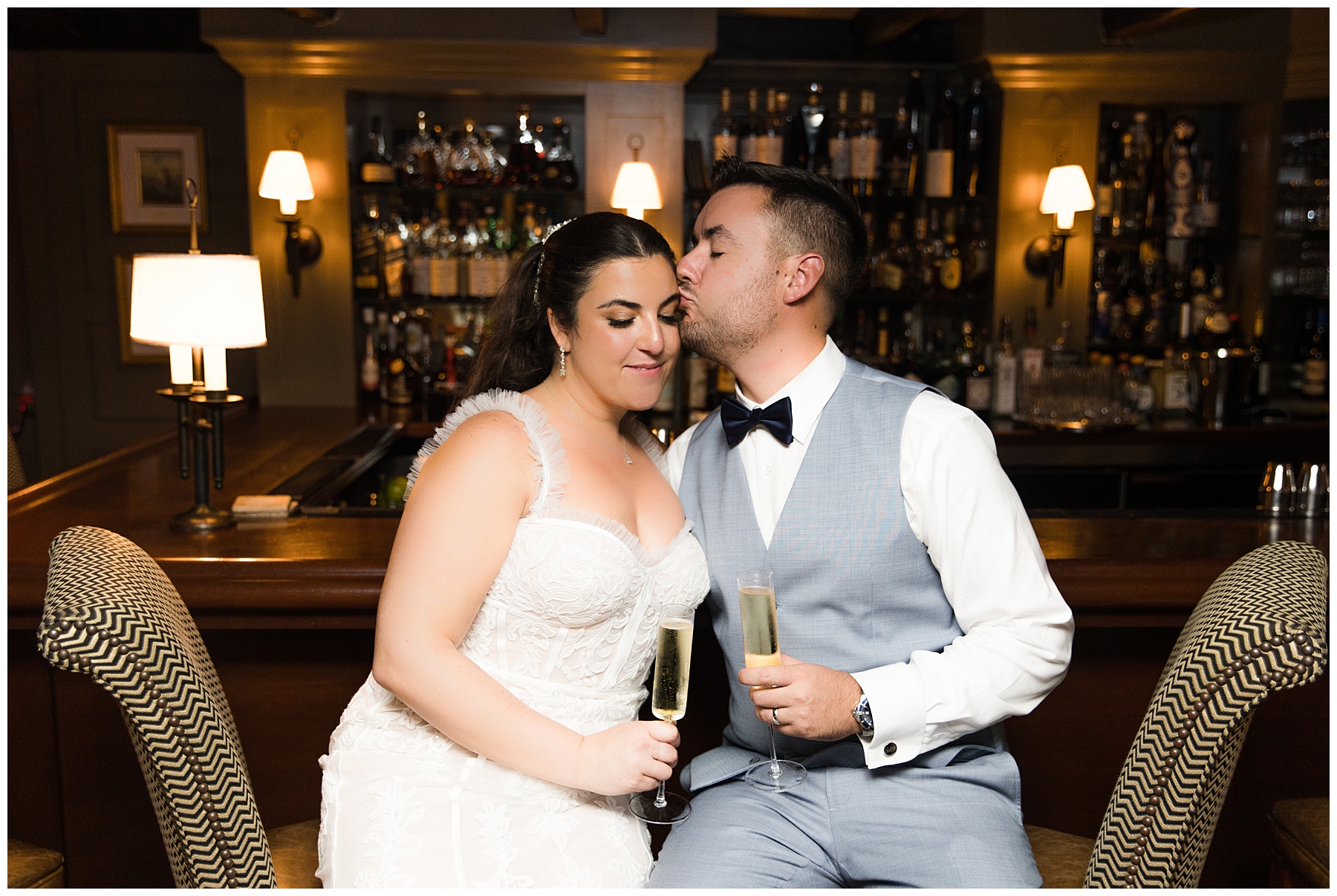 newlyweds share glass of champagne at the end of wedding day