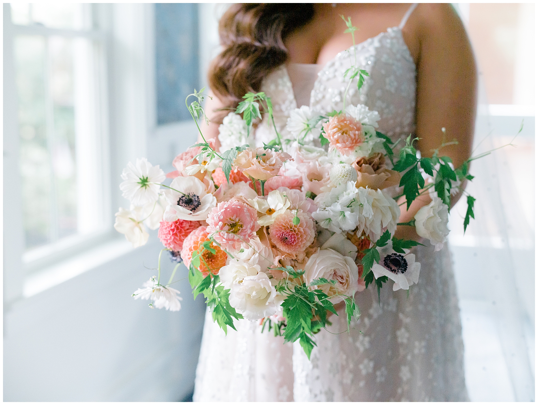 bridal bouquets of white, coral, and pale orange flowers