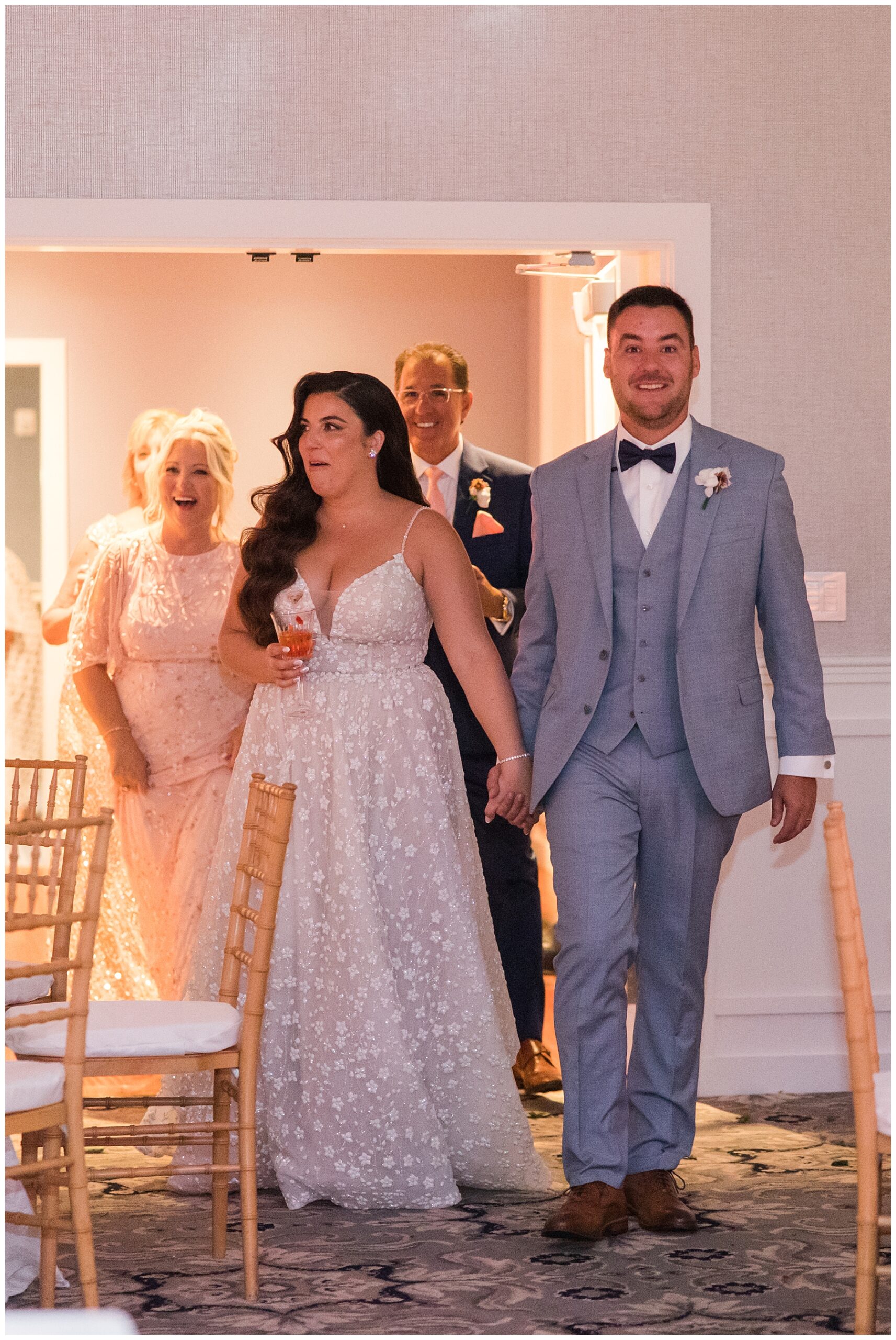 newlyweds enter wedding reception