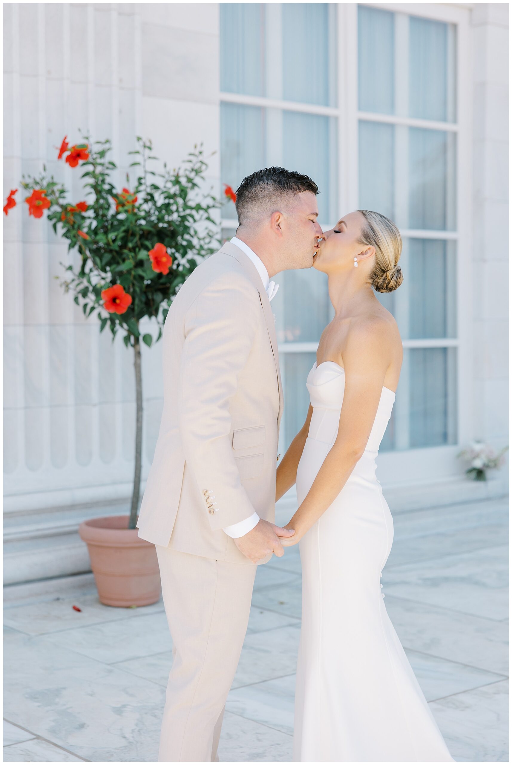 bride and groom kiss during wedding portraits 