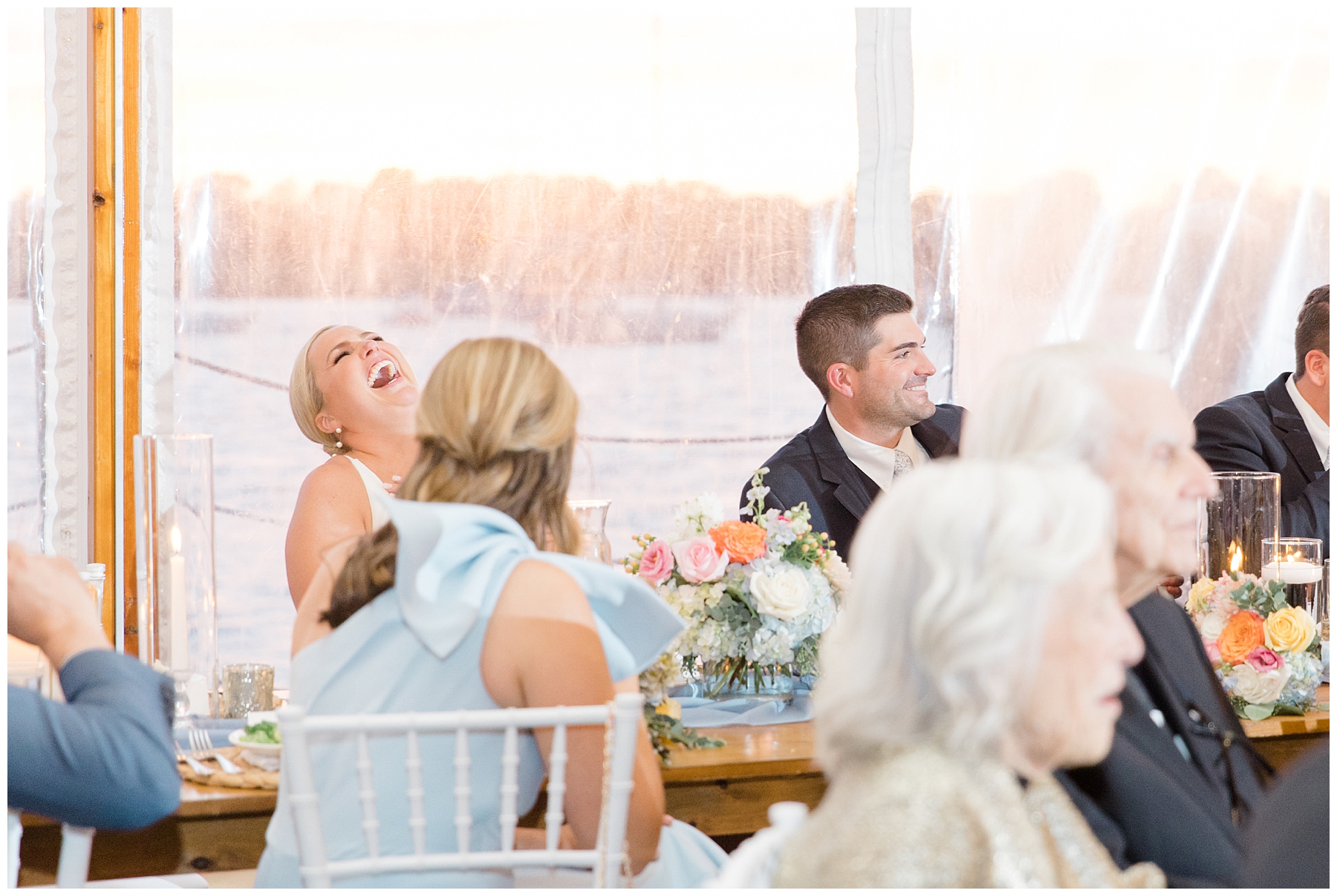 couple laugh during wedding toasts