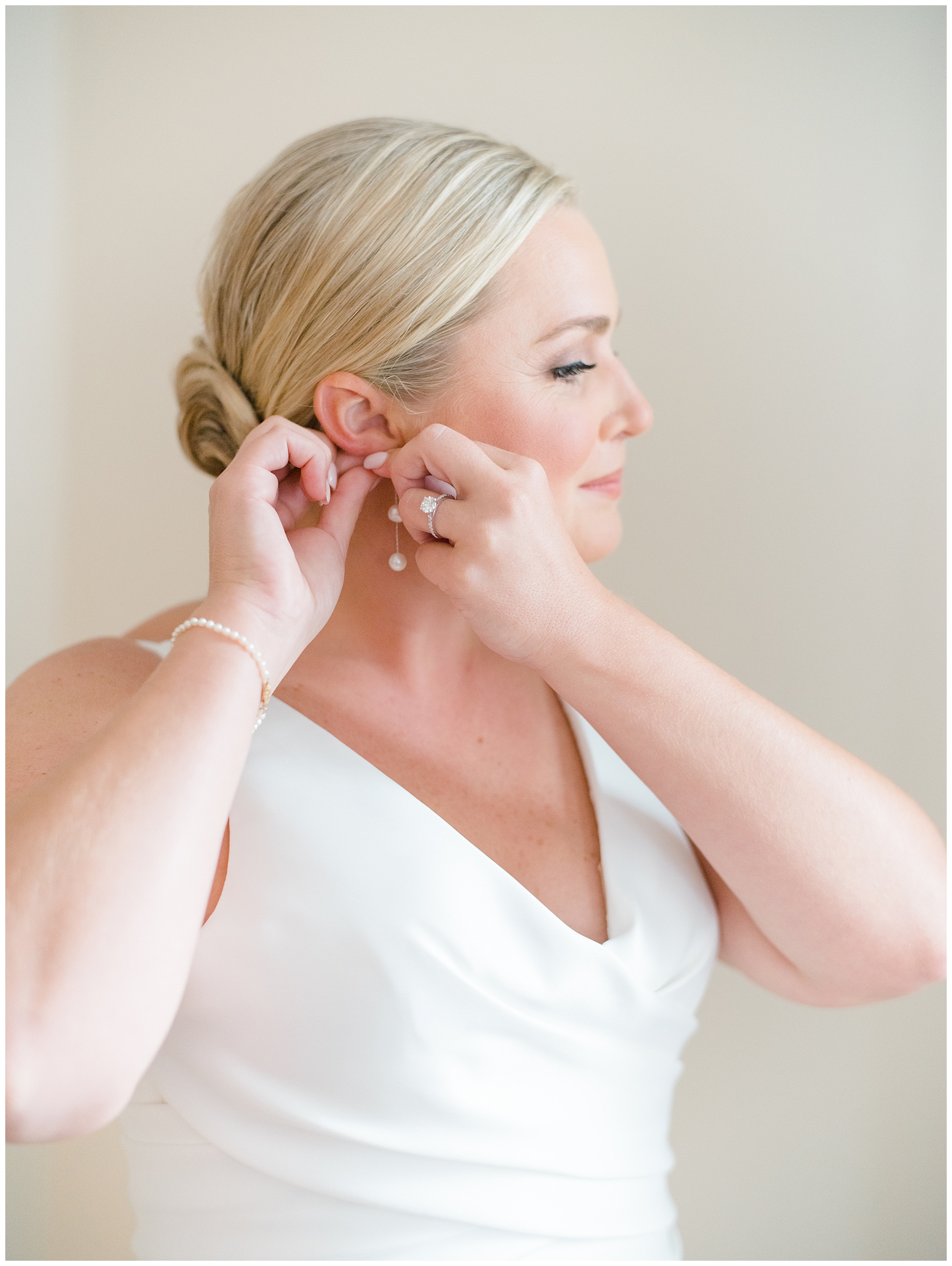 bride putting in earrings