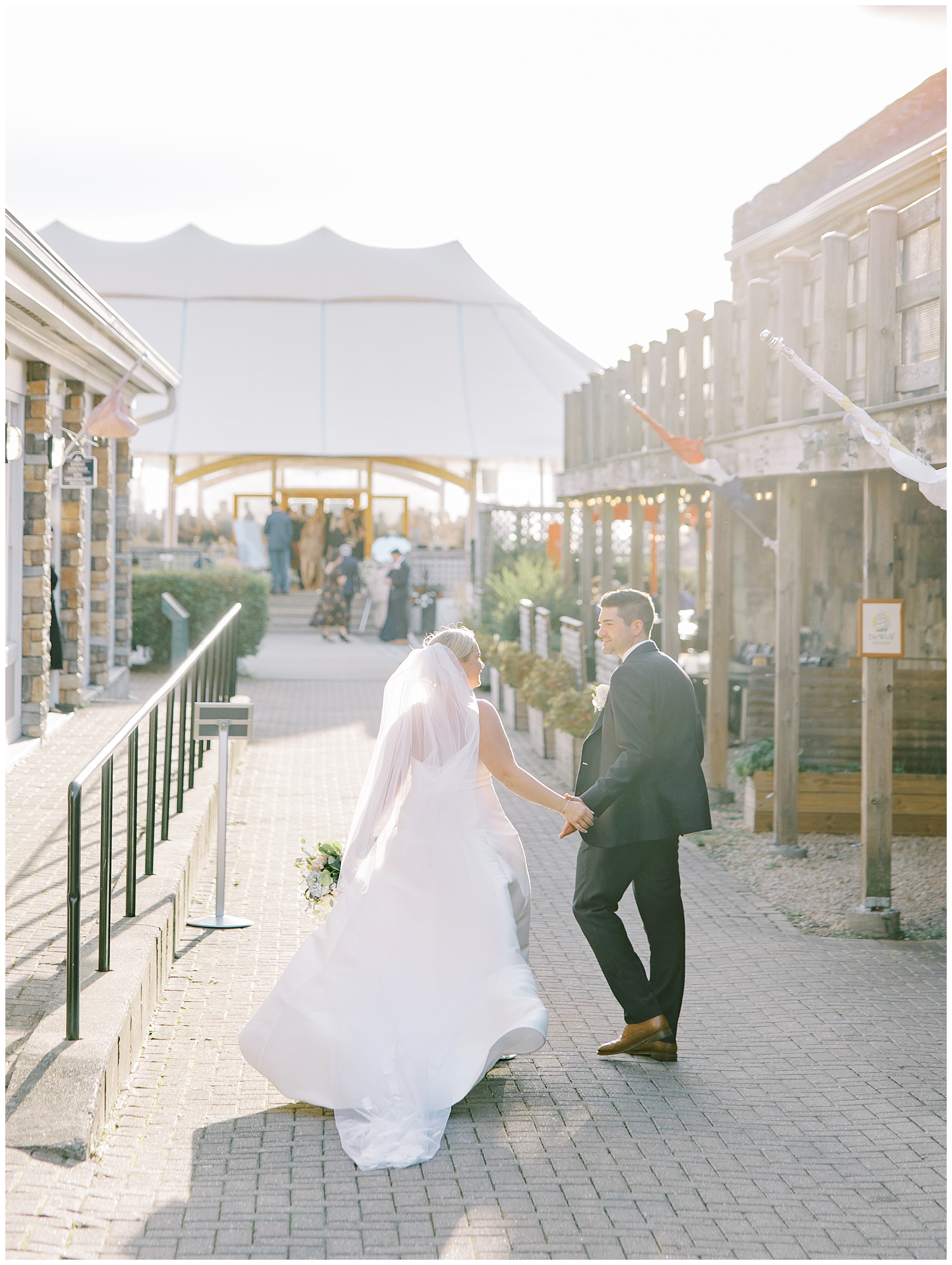bride and groom walk towards reception rent at The Bristol harbor inn
