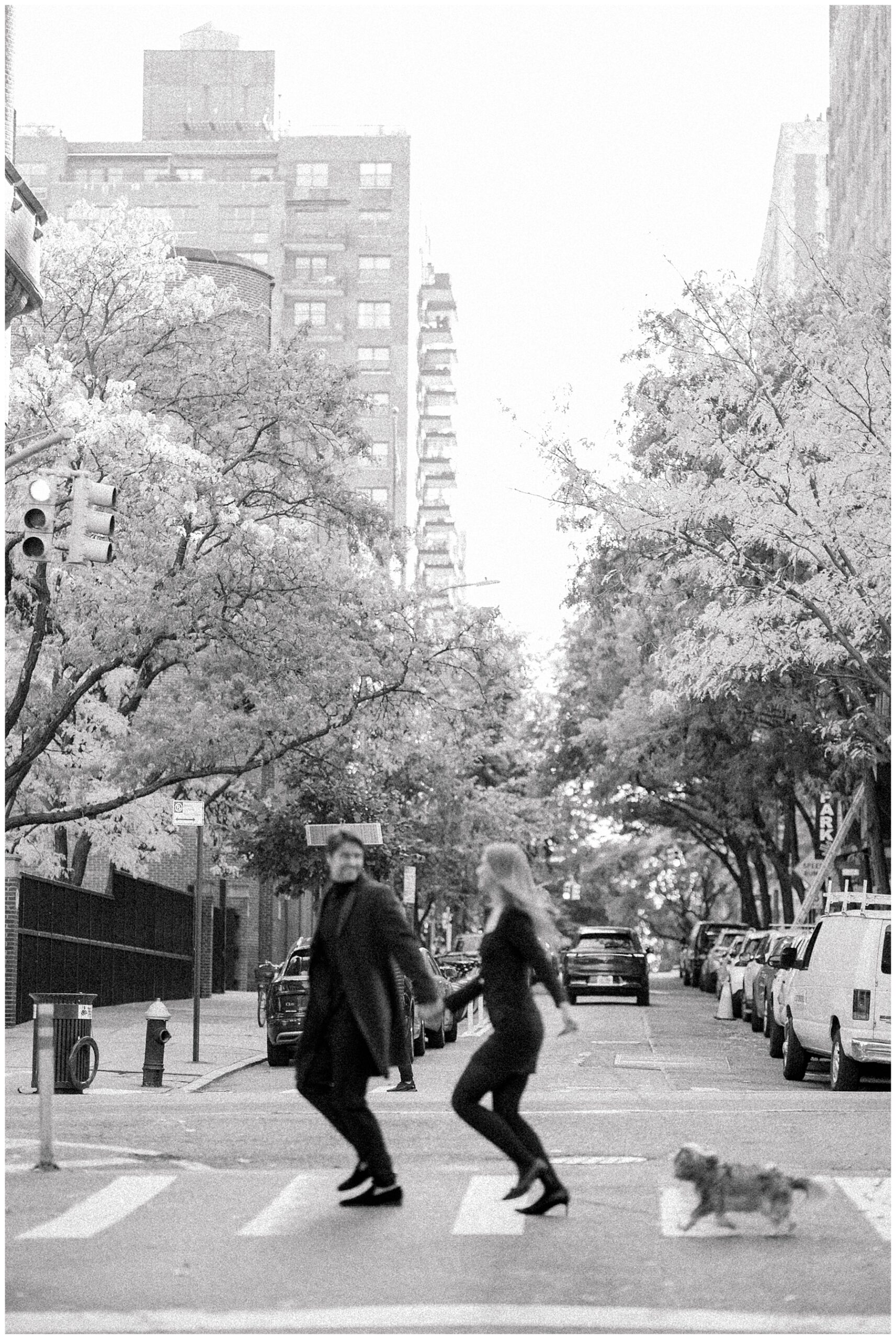 couple walk across street in NY during engagement session