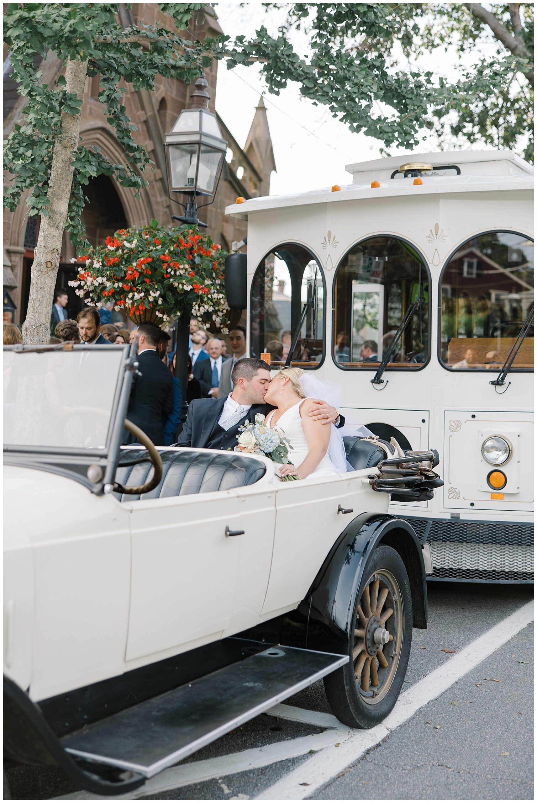newlyweds in the back of vintage getaway car