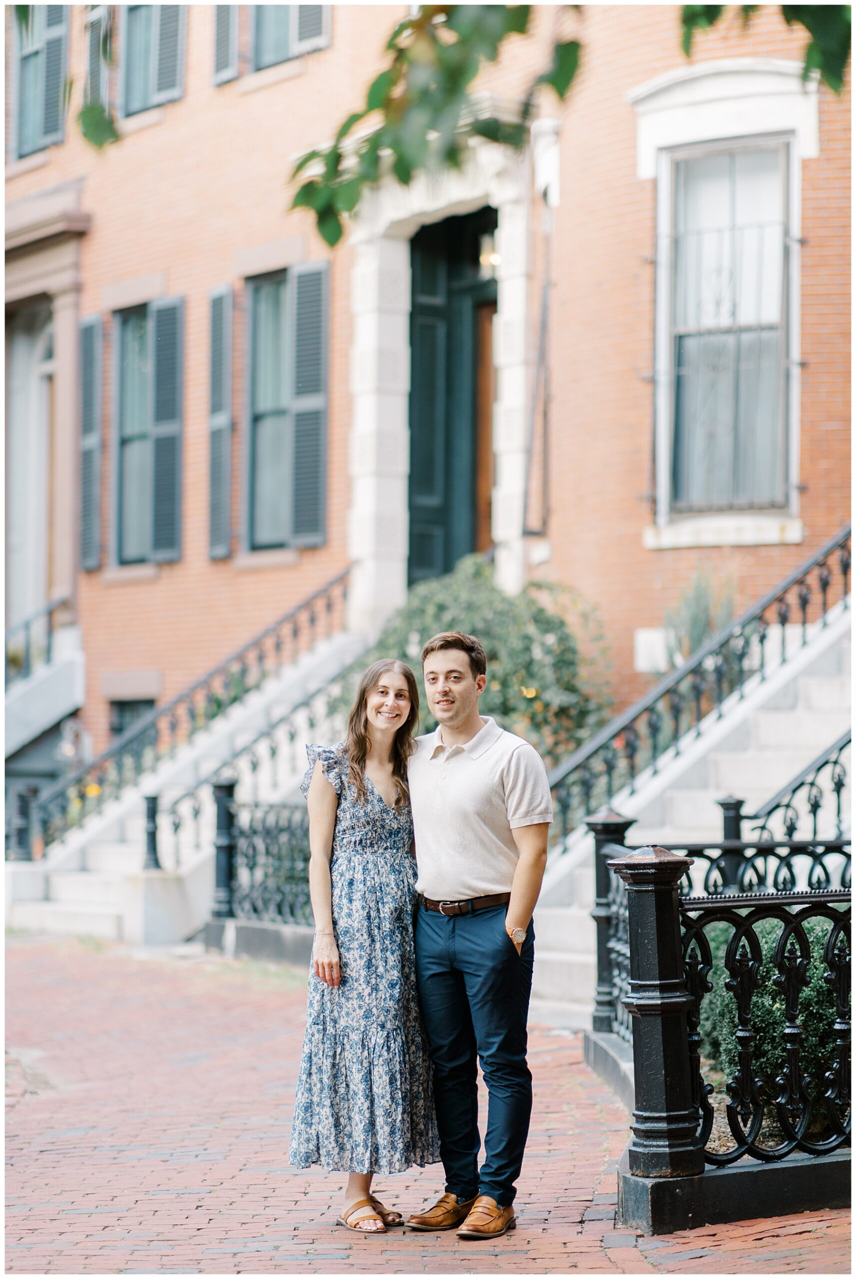 engaged couple in front of historic brownstones in Boston neighborhod