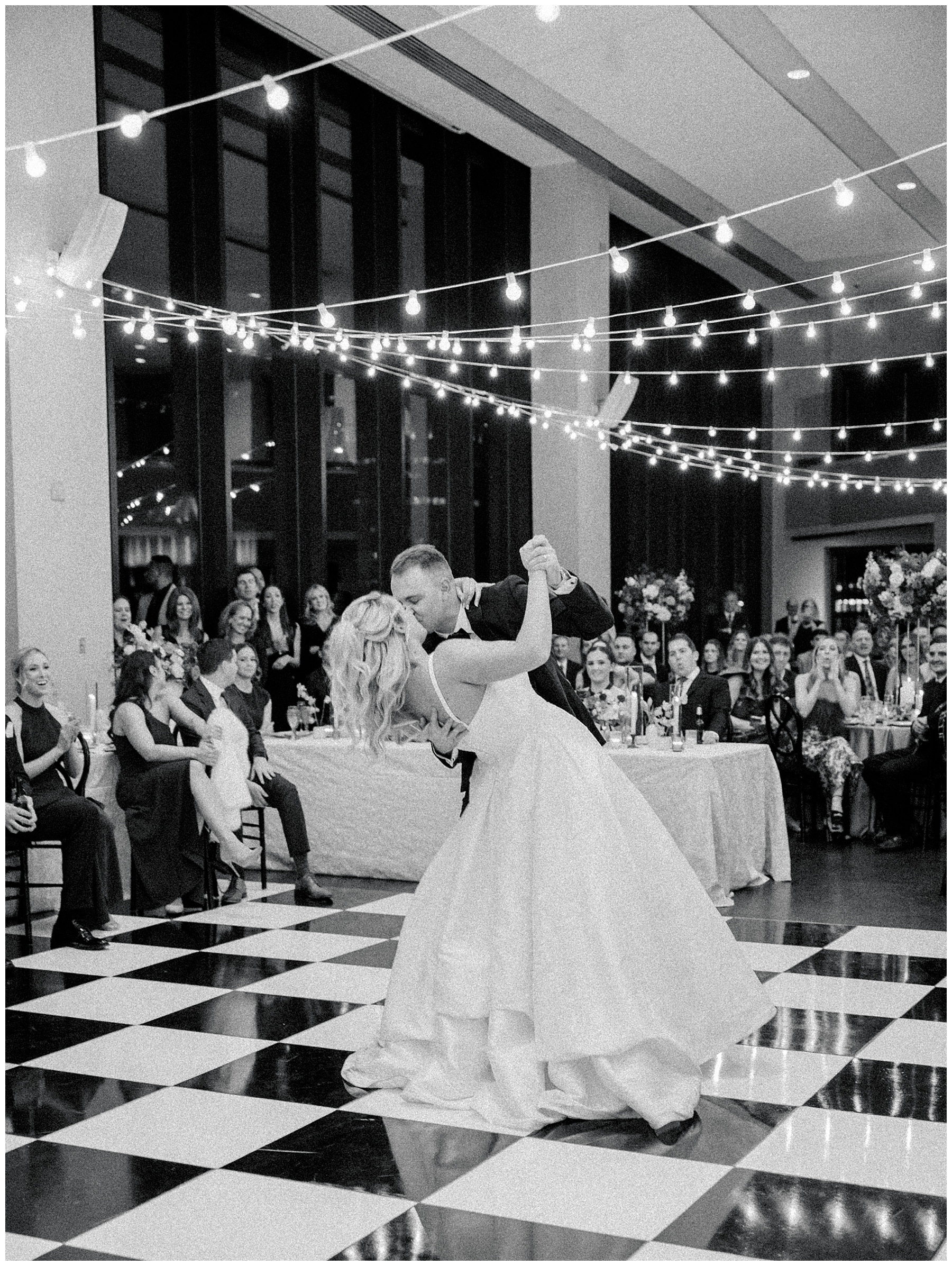 groom kisses and dips his bride on the dance floor