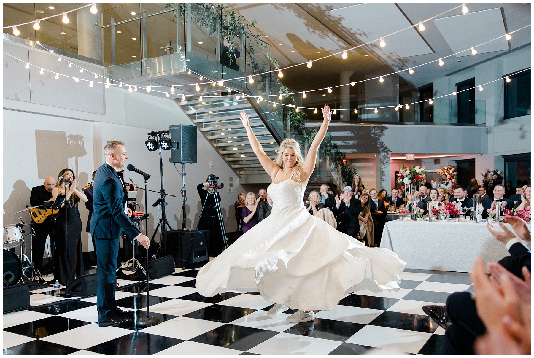 groom spins the bride on dance floor