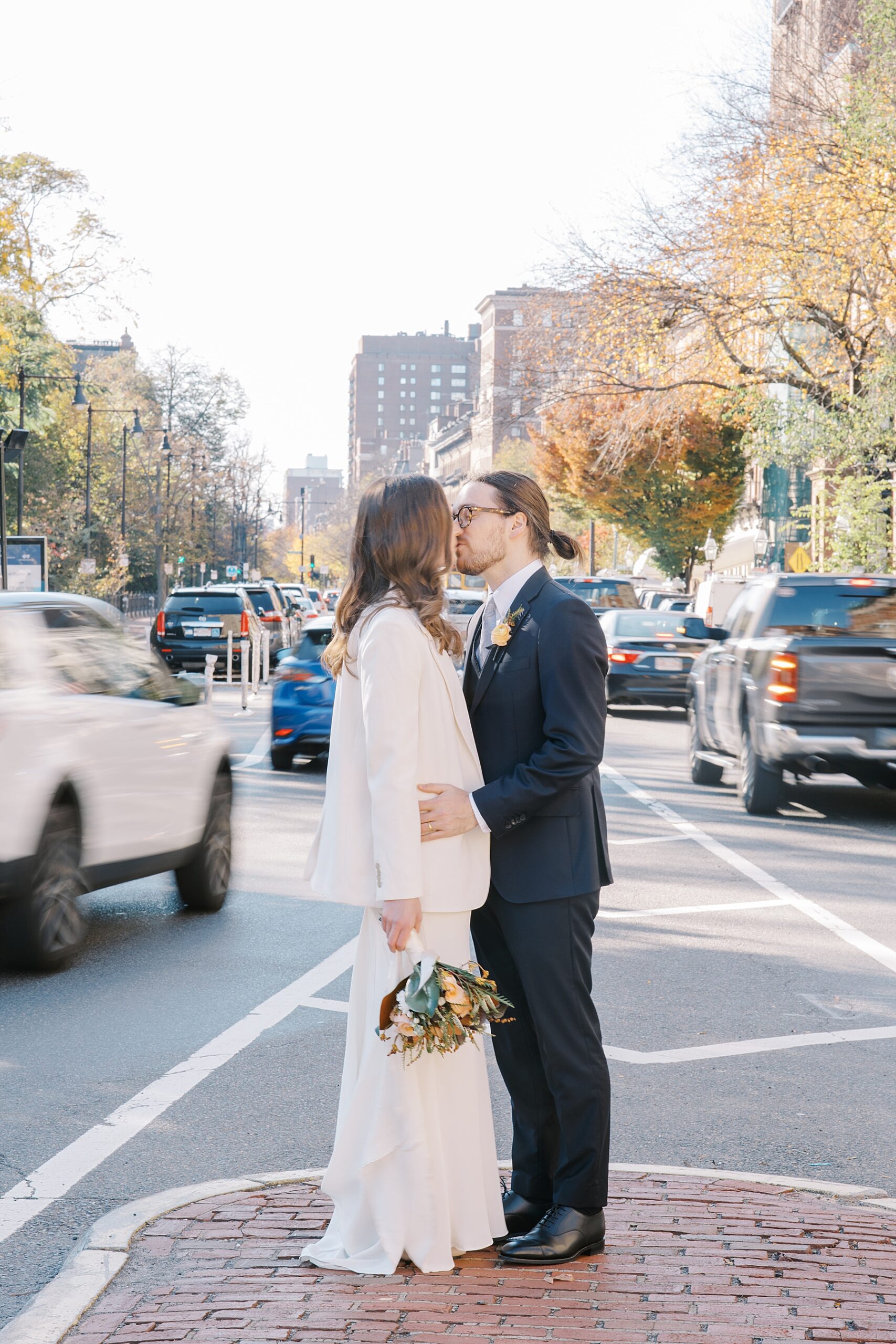 newlyweds kiss near busy Boston street