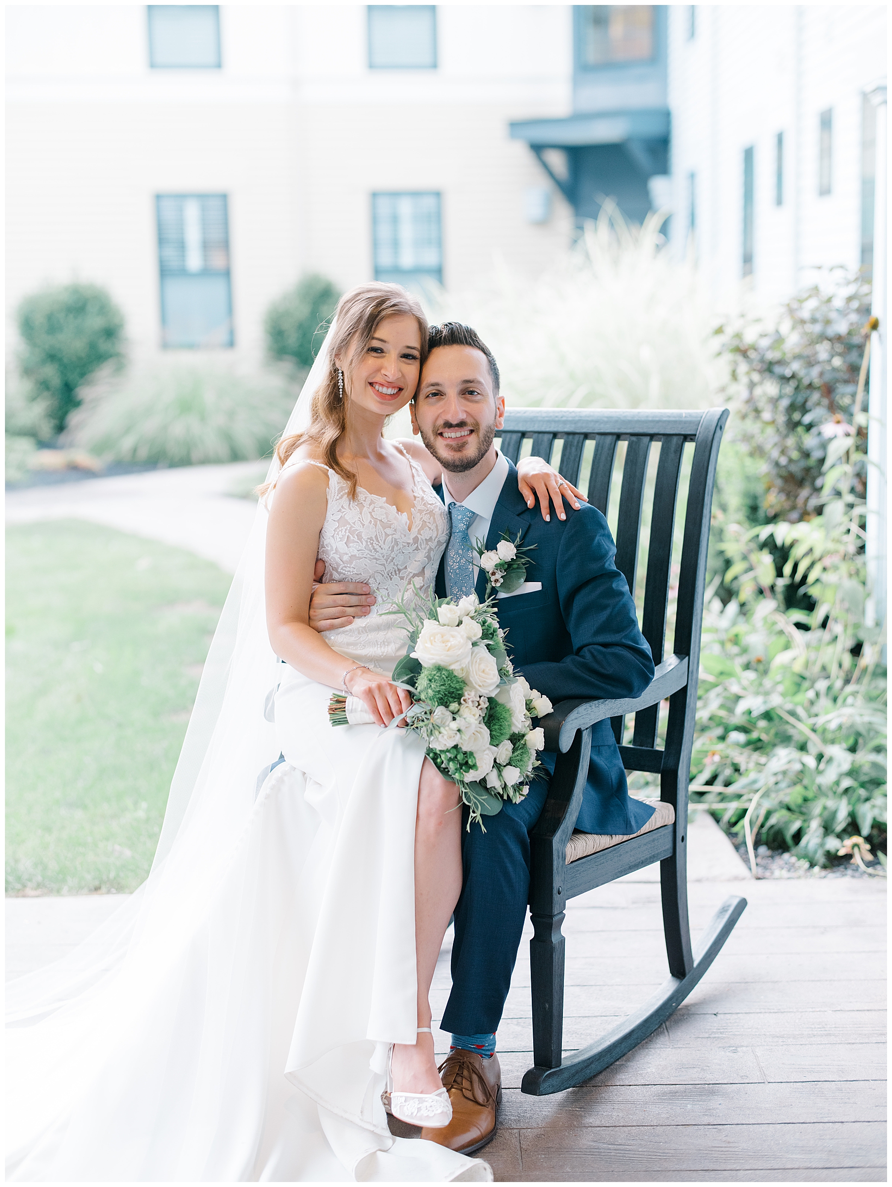 newlyweds sit together on rocking chair 