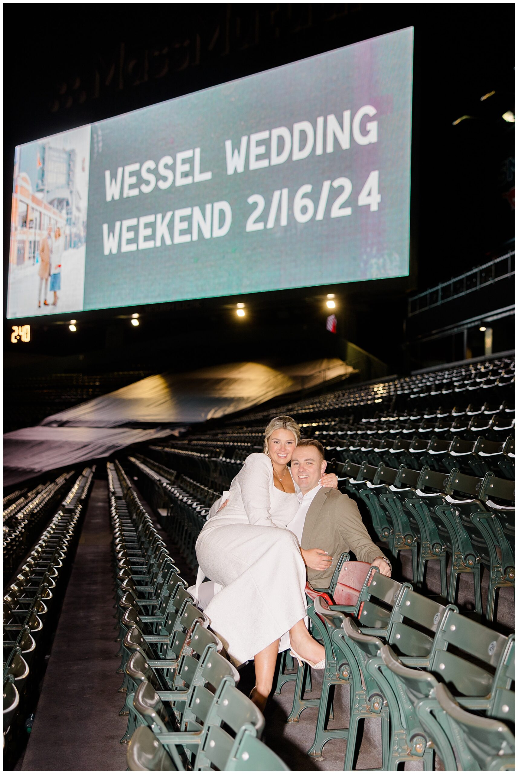 couple sit in Boston Red Sox Stadium the night before their wedding 