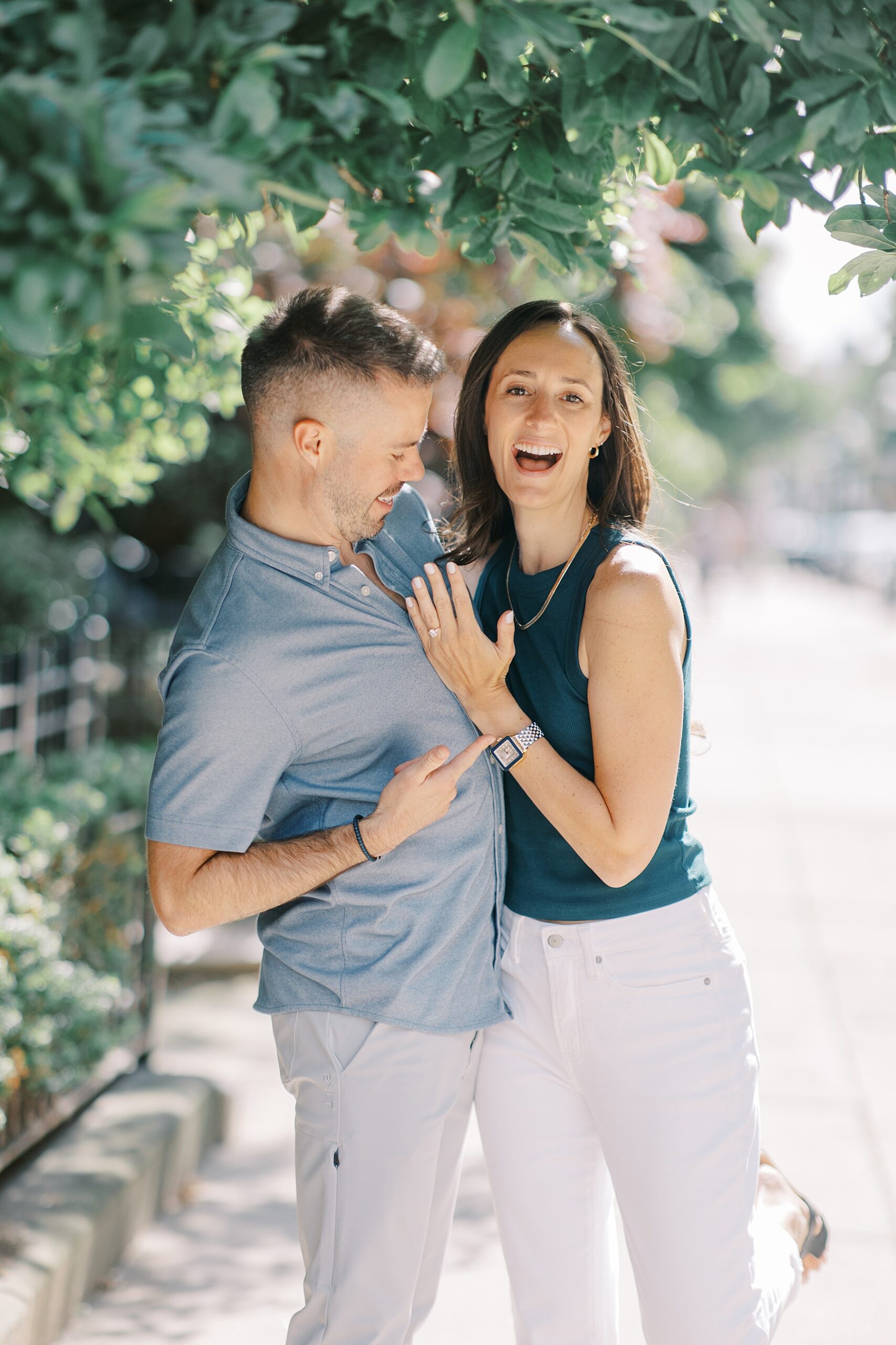 newly engaged couple show off engagement ring after Epic Rooftop Proposal in Boston