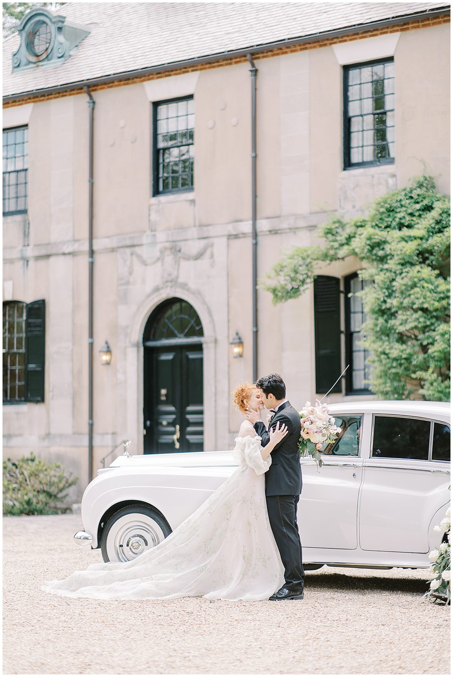 newlyweds kiss by vintage car