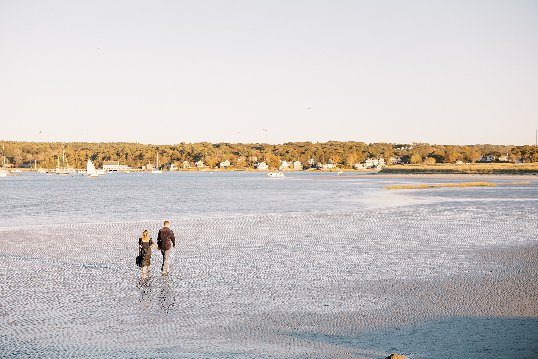 couple walk in the water at Wingaersheek Beach