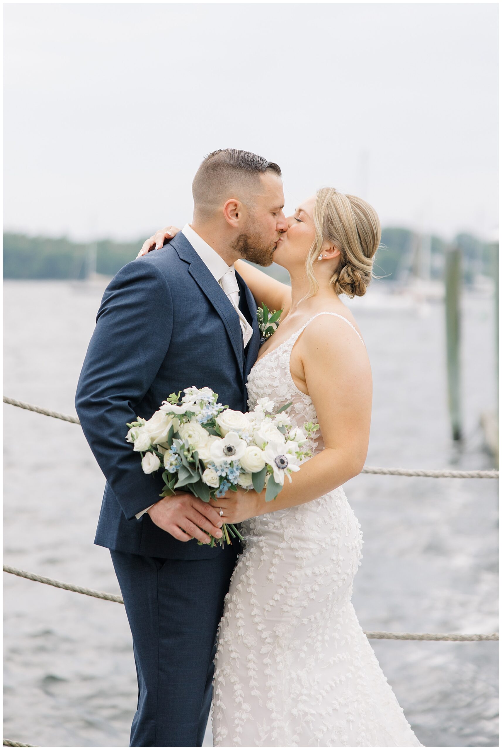 bride and groom kiss on the dock 