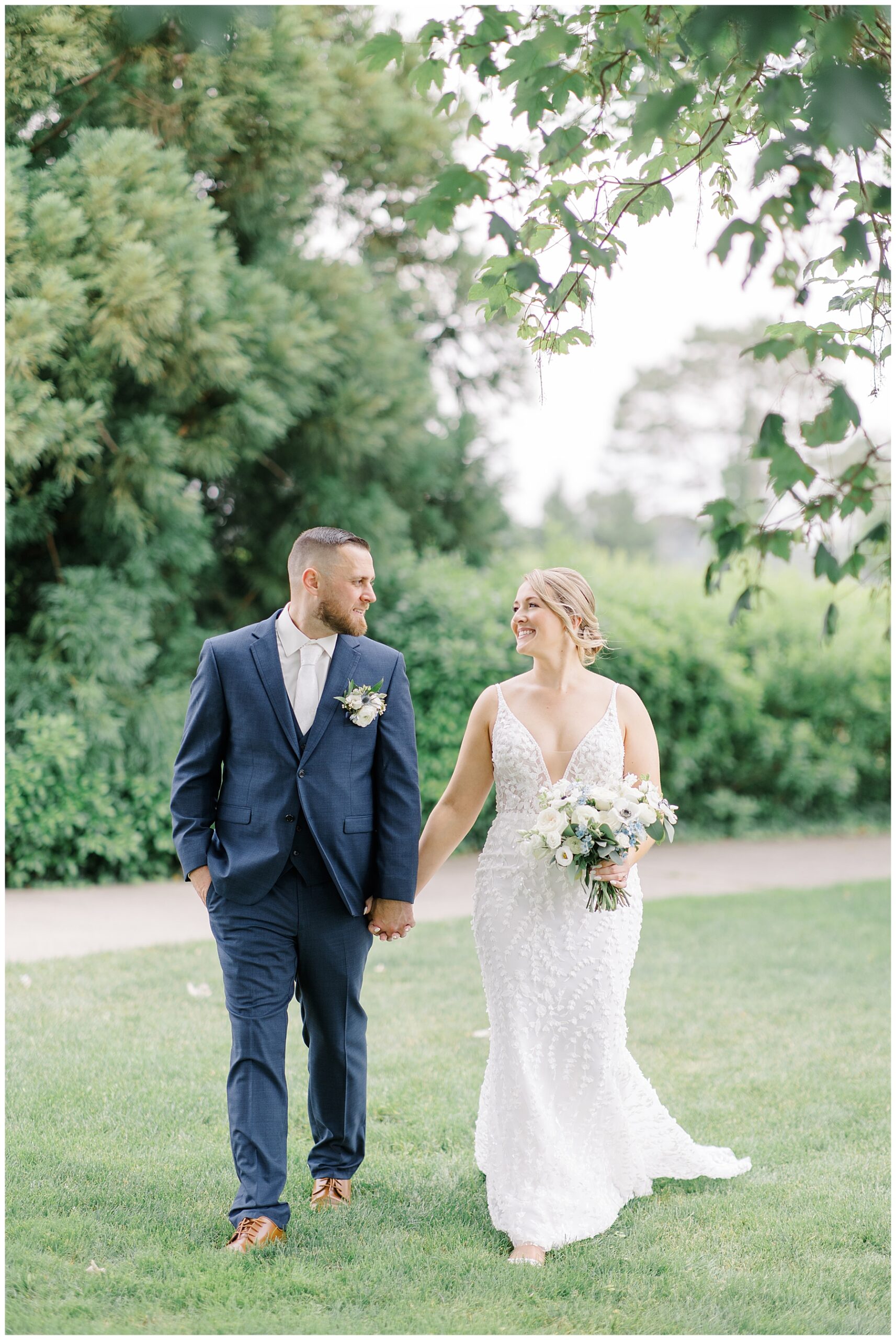 bride and groom hold hands 