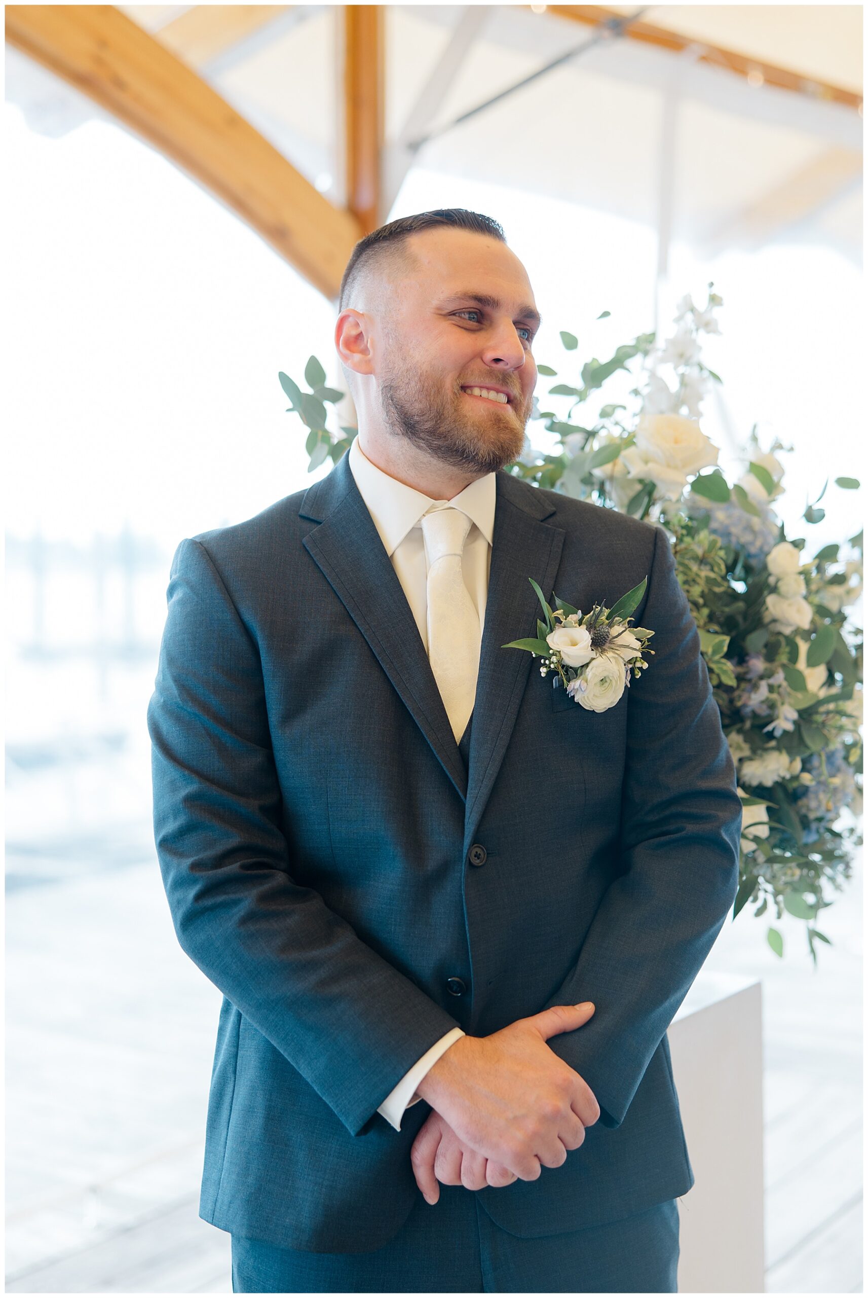 groom watches his bride walk down the aisle 