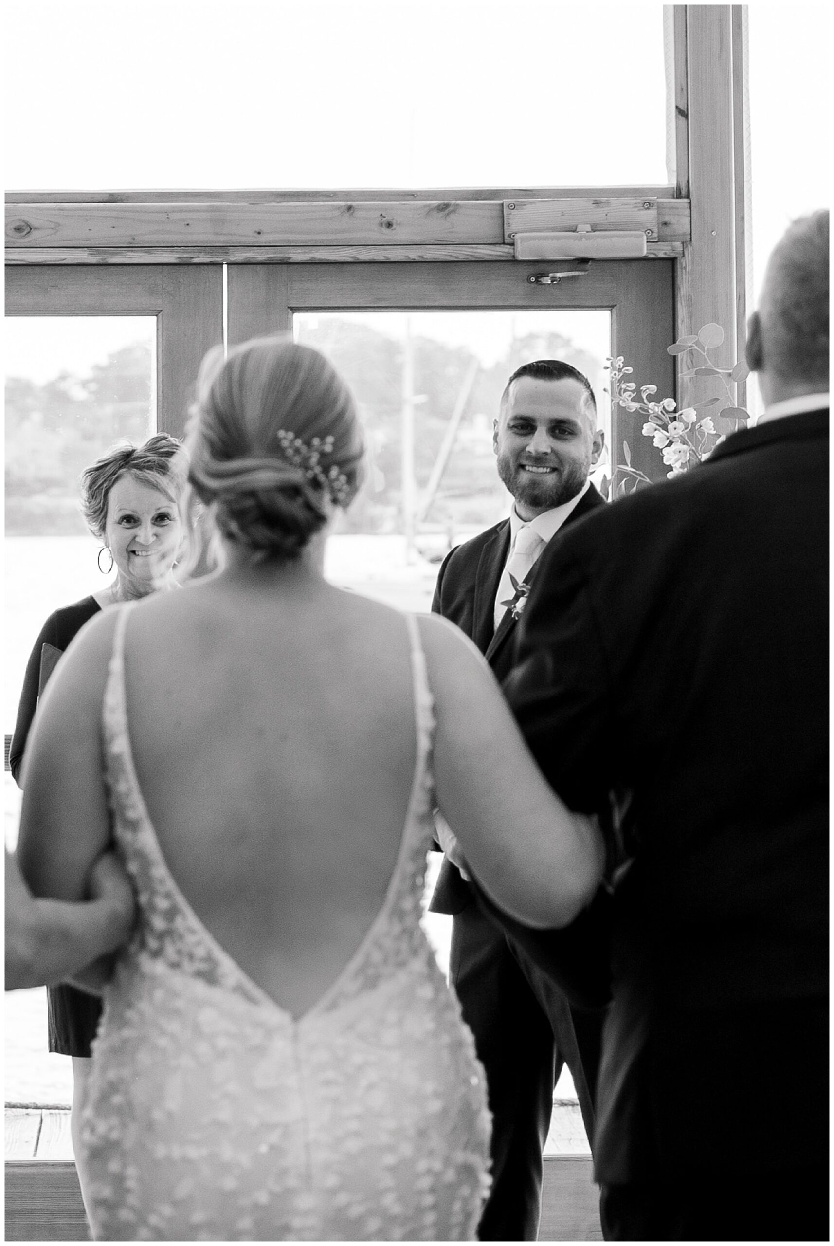 groom watches bride walk towards him during wedding ceremony 