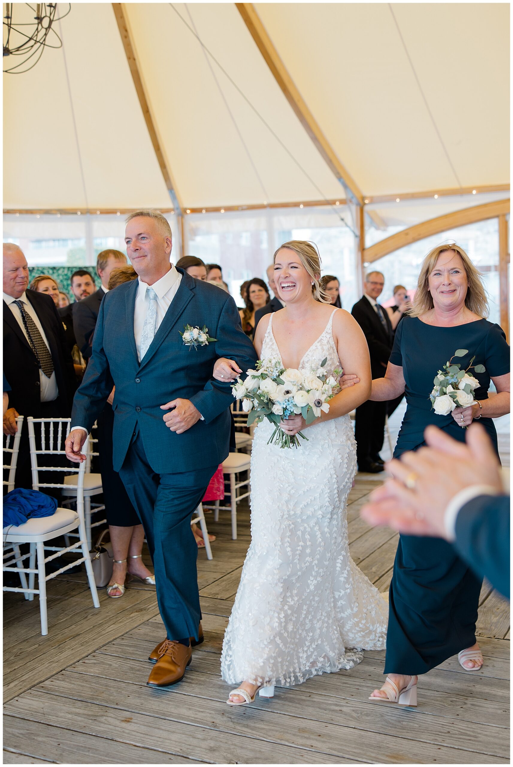 parents escort their daughter down the aisle 