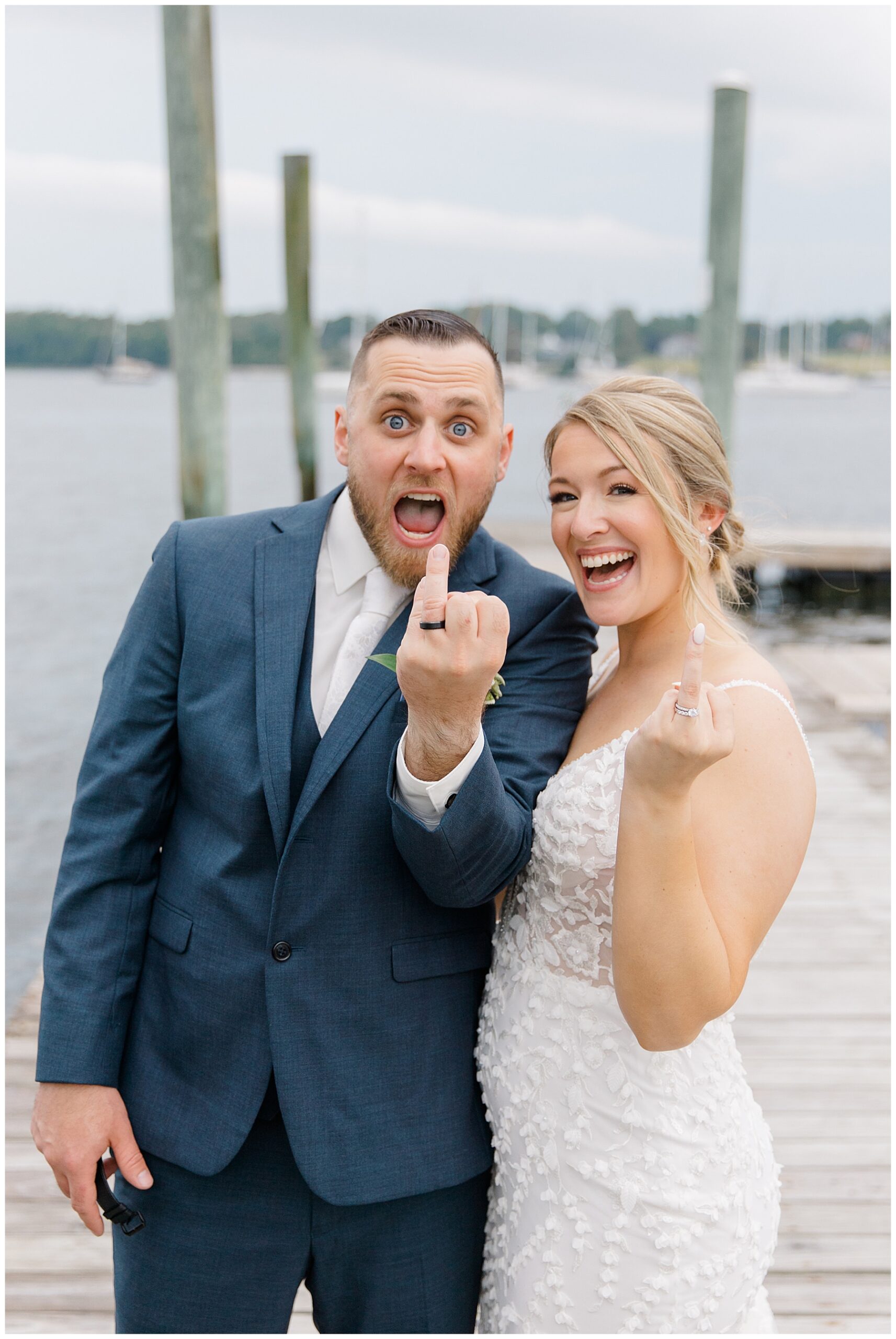 bride and groom show off their wedding rings