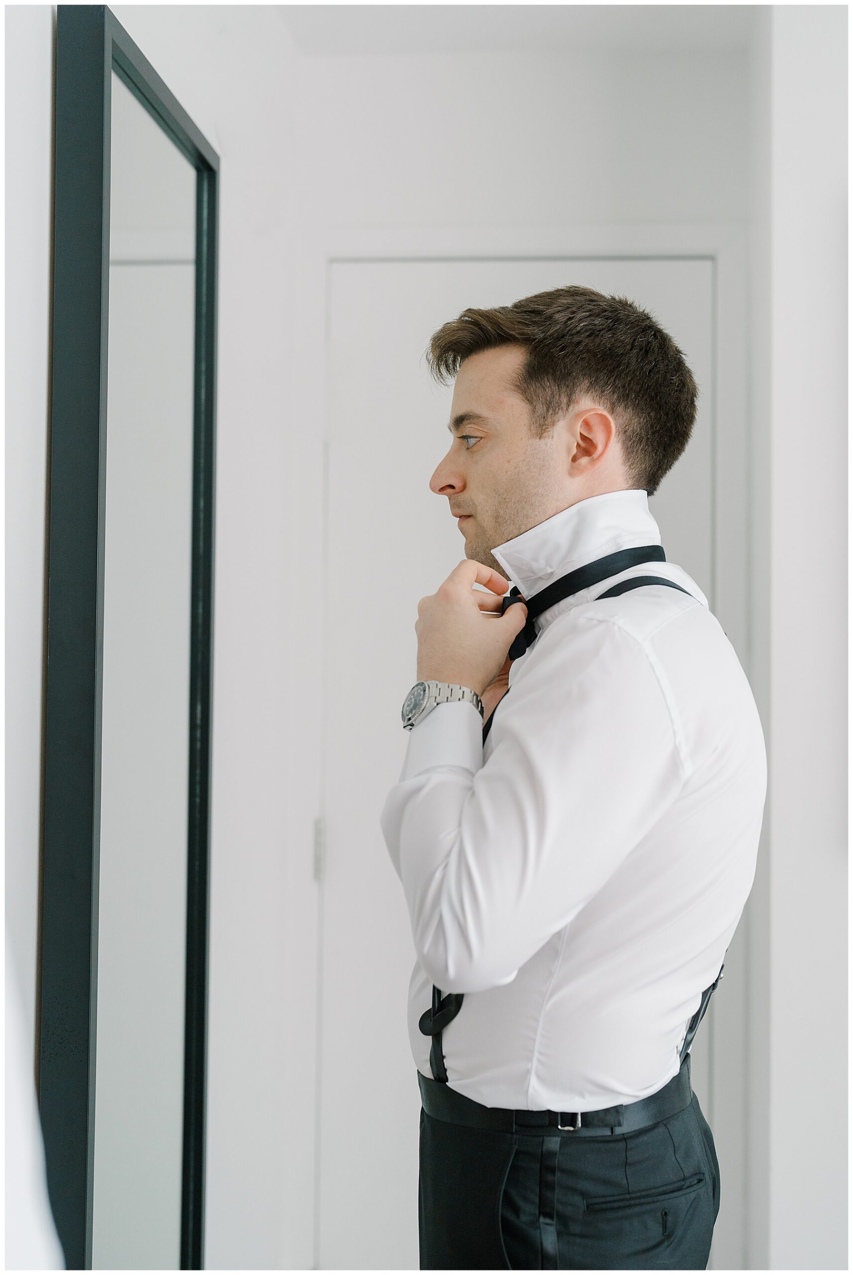 groom putting on bowtie