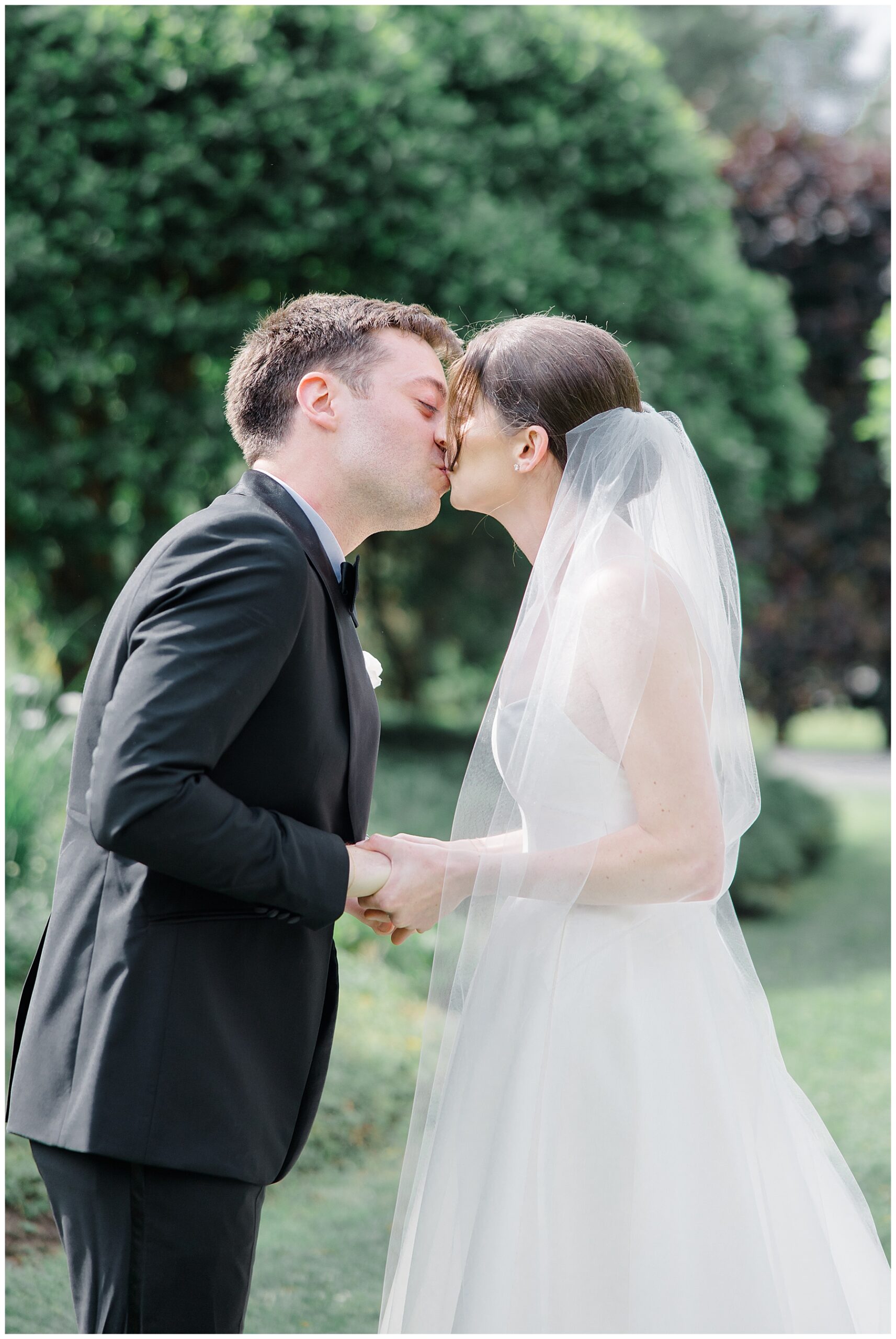 bride and groom kiss during first look