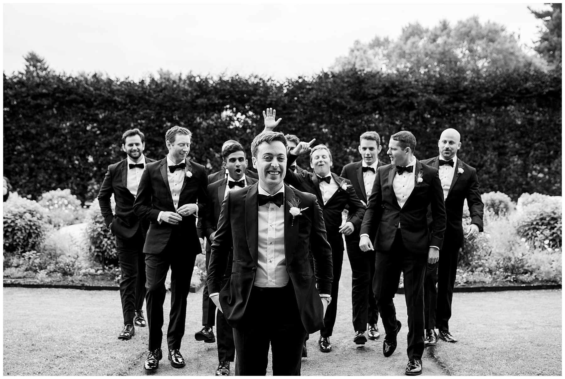 groomsmen walk behind groom