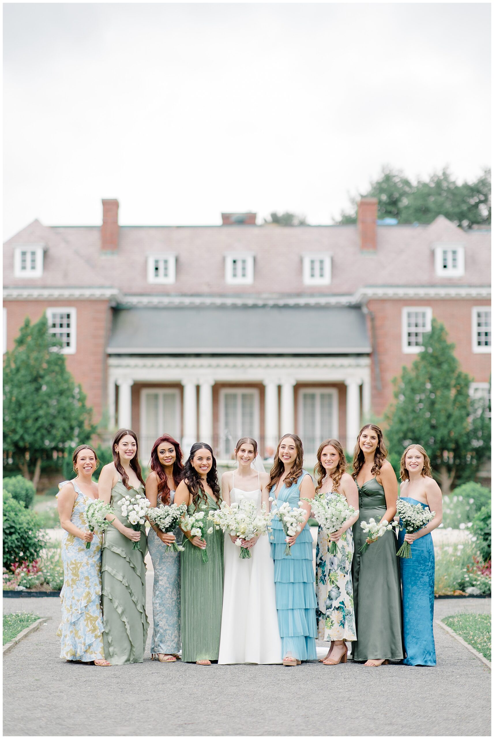 bridal party in front of building at The Gardens at Elm Bank  